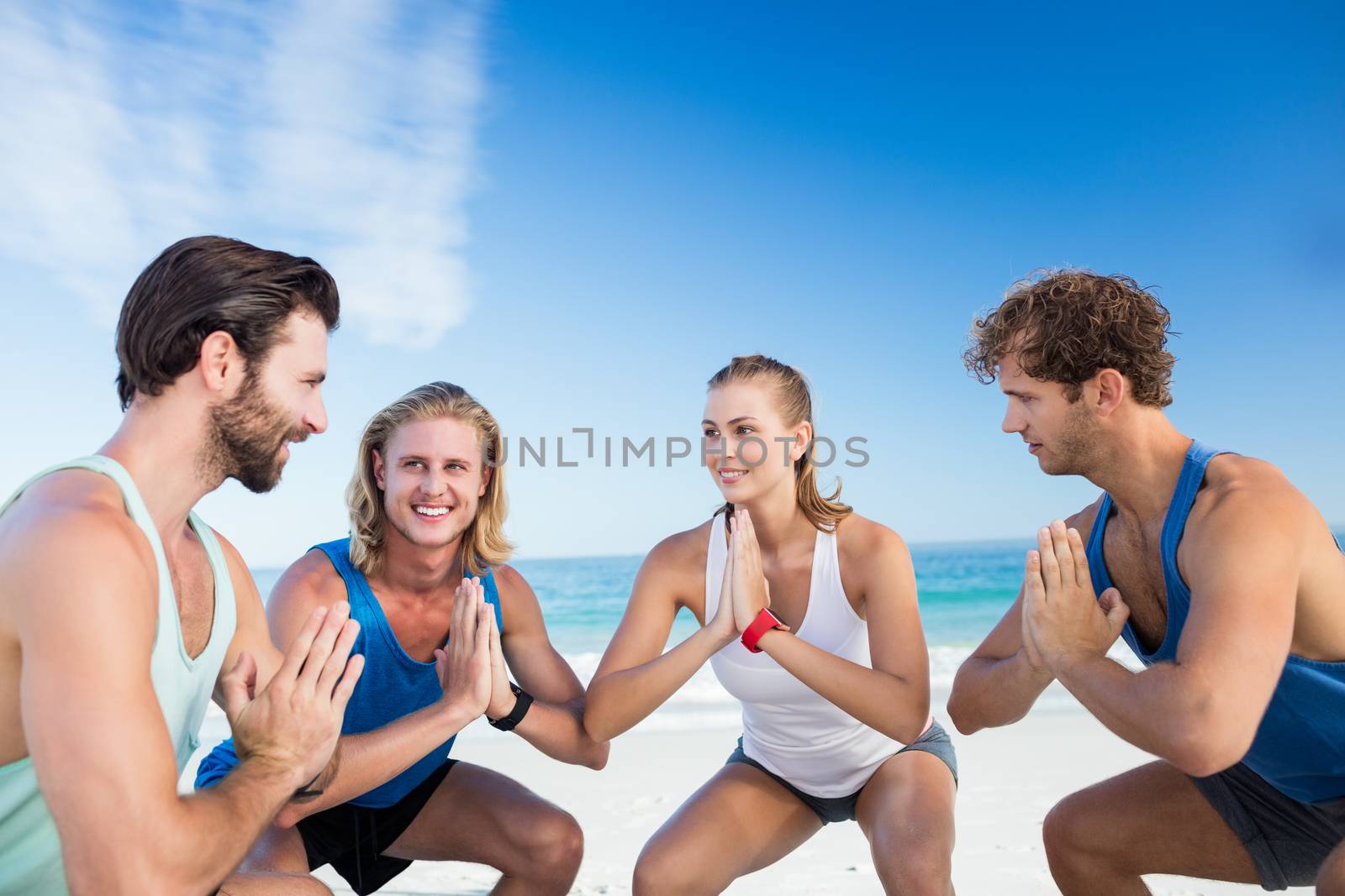 People exercising on the beach by Wavebreakmedia