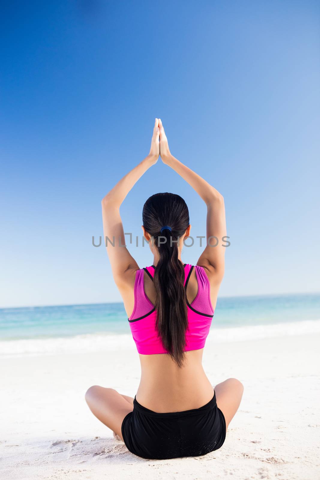 Woman doing yoga on the beach by Wavebreakmedia