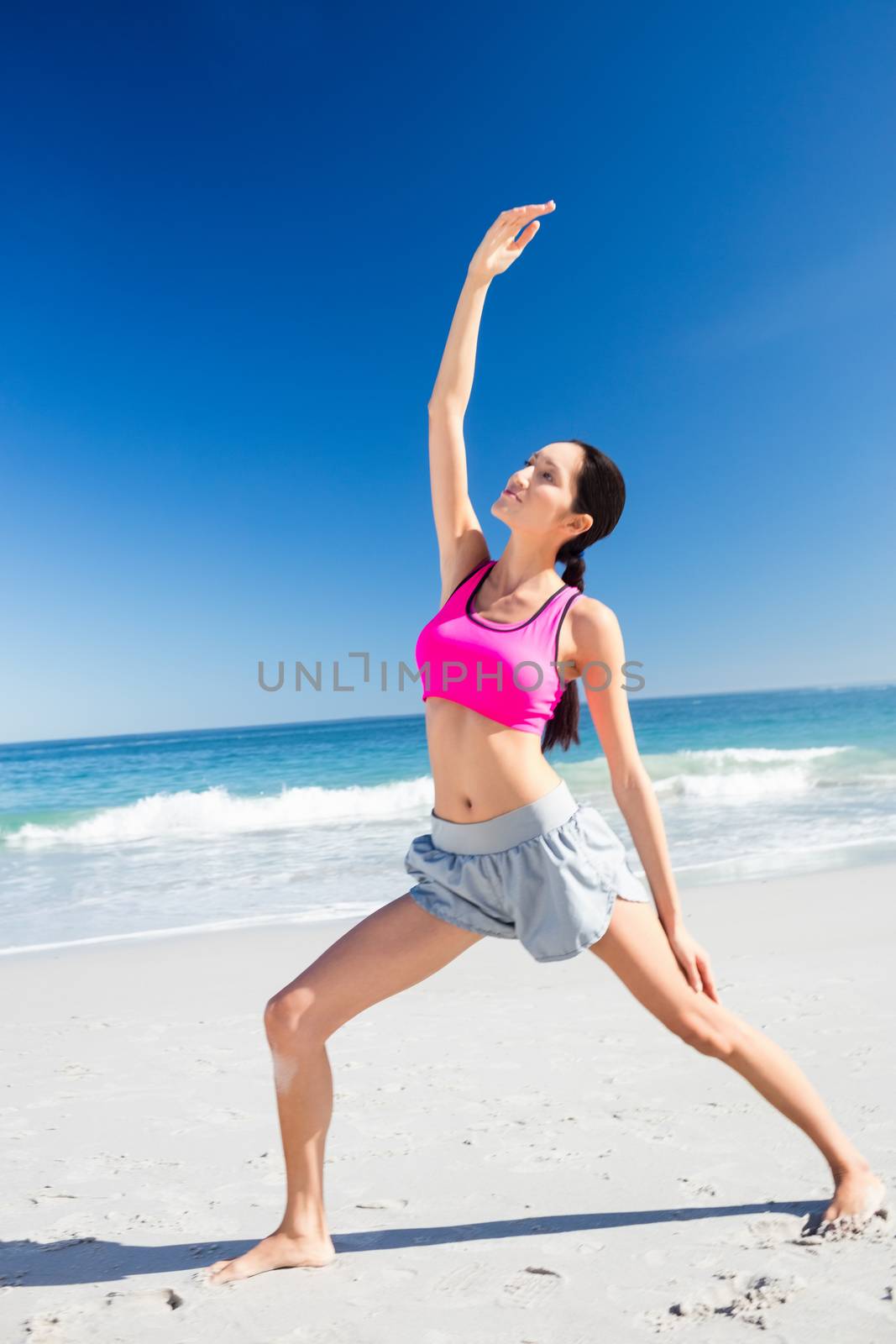 Woman doing yoga on the beach by Wavebreakmedia