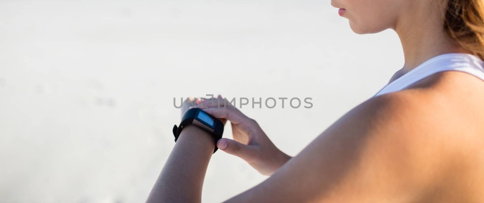 Woman using a smart watch by Wavebreakmedia