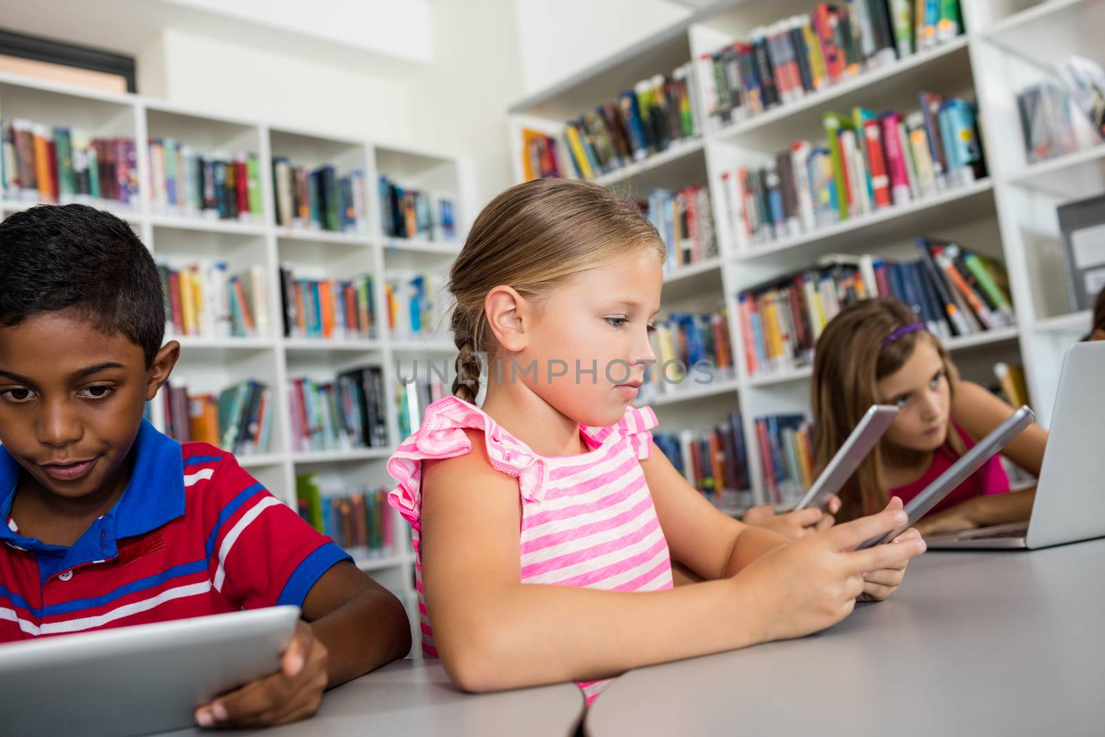 Children are using technology in library