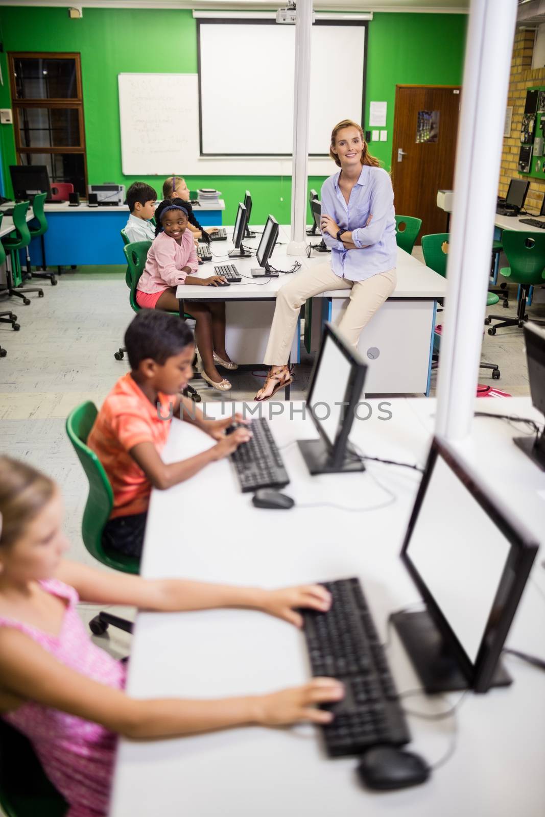 Teacher giving lesson to her students with technology by Wavebreakmedia