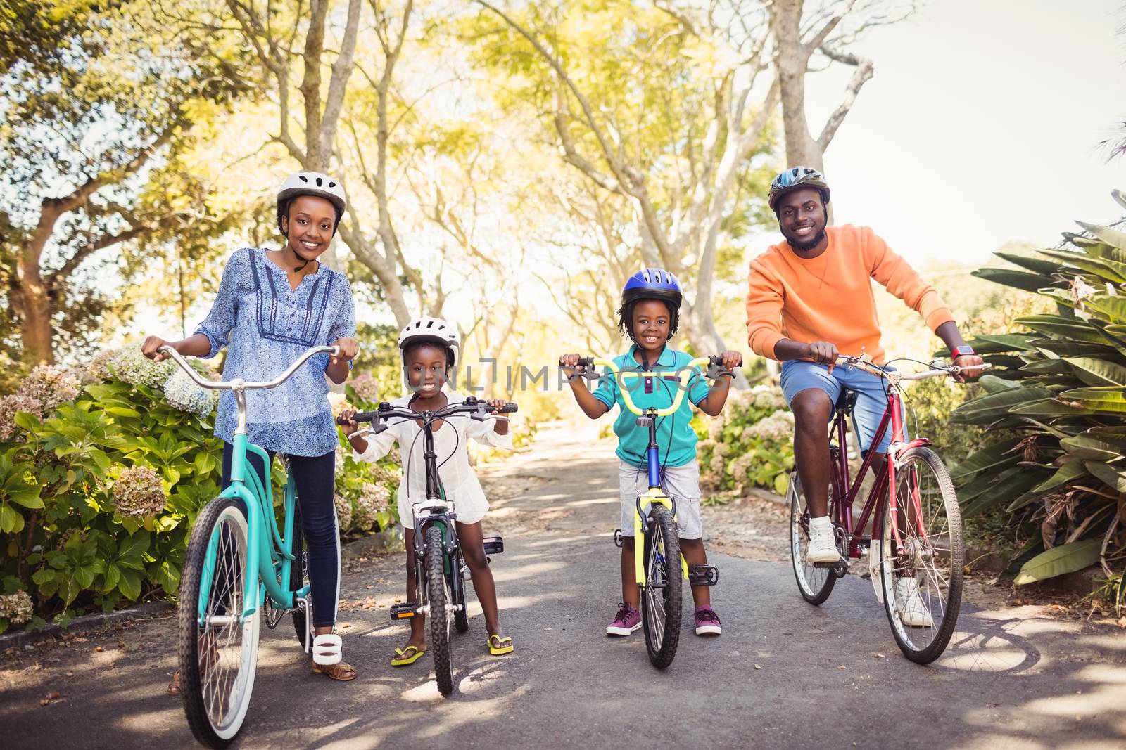 Happy family doing bicycle by Wavebreakmedia
