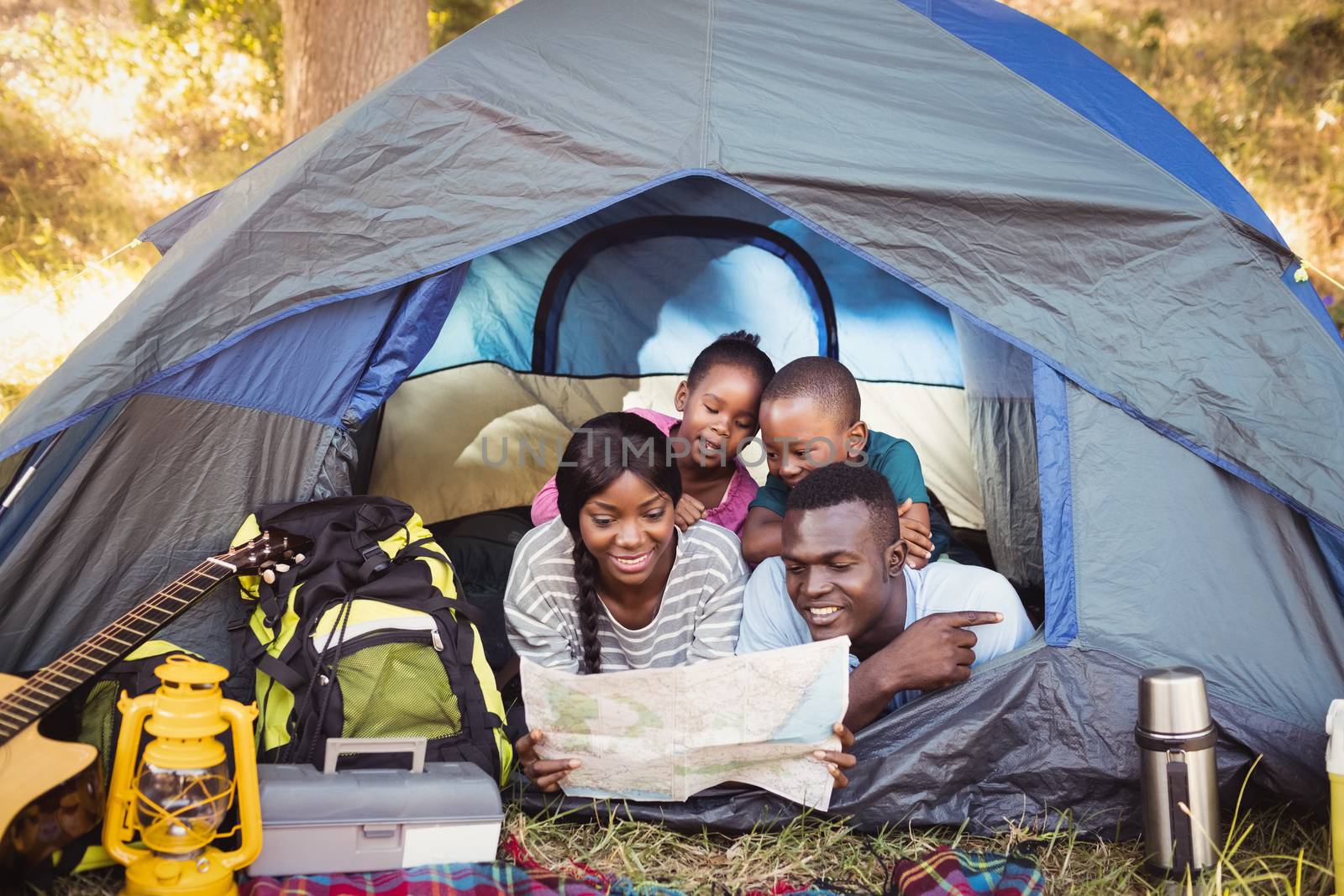 Happy family lying together at park