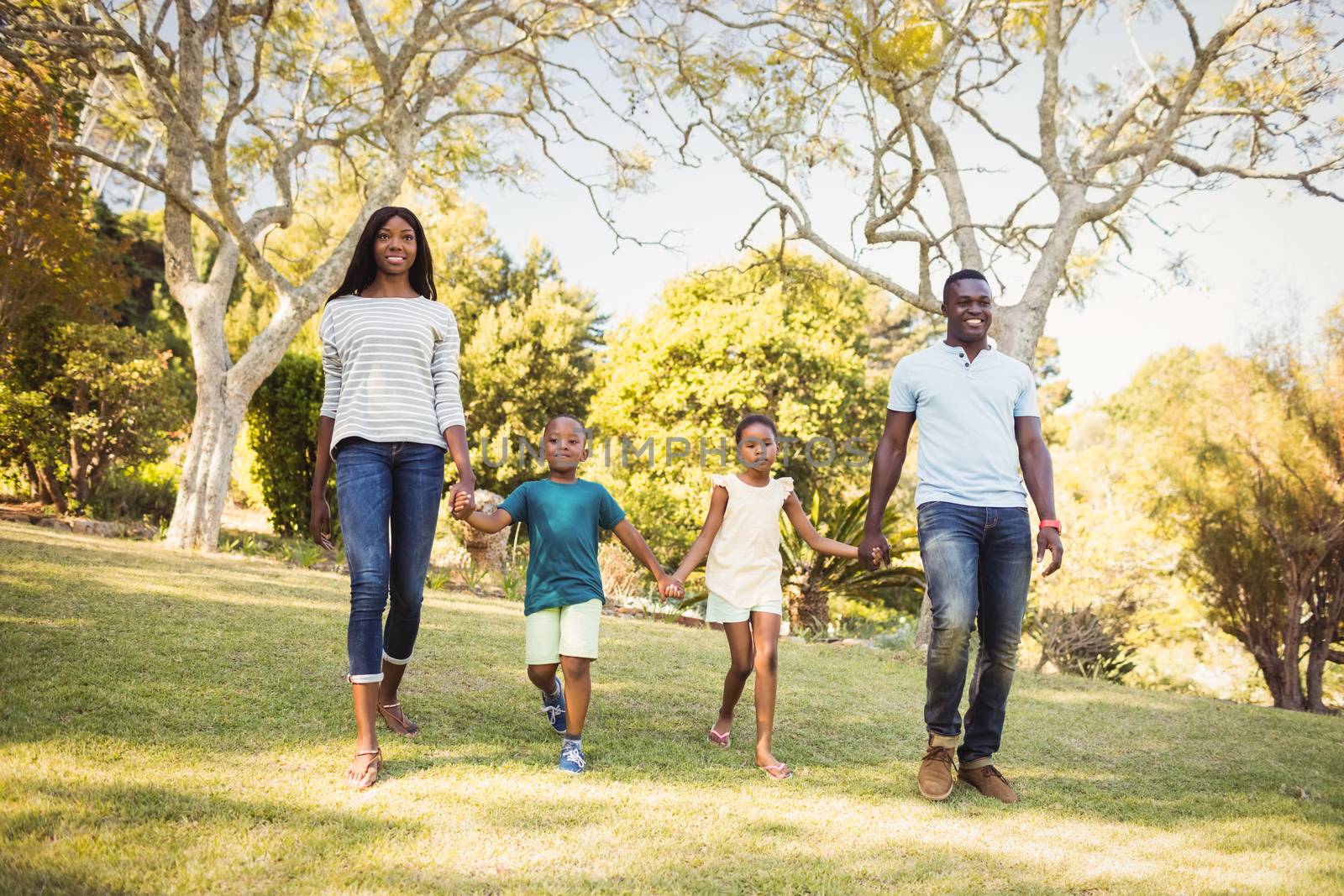 Happy family walking together by Wavebreakmedia