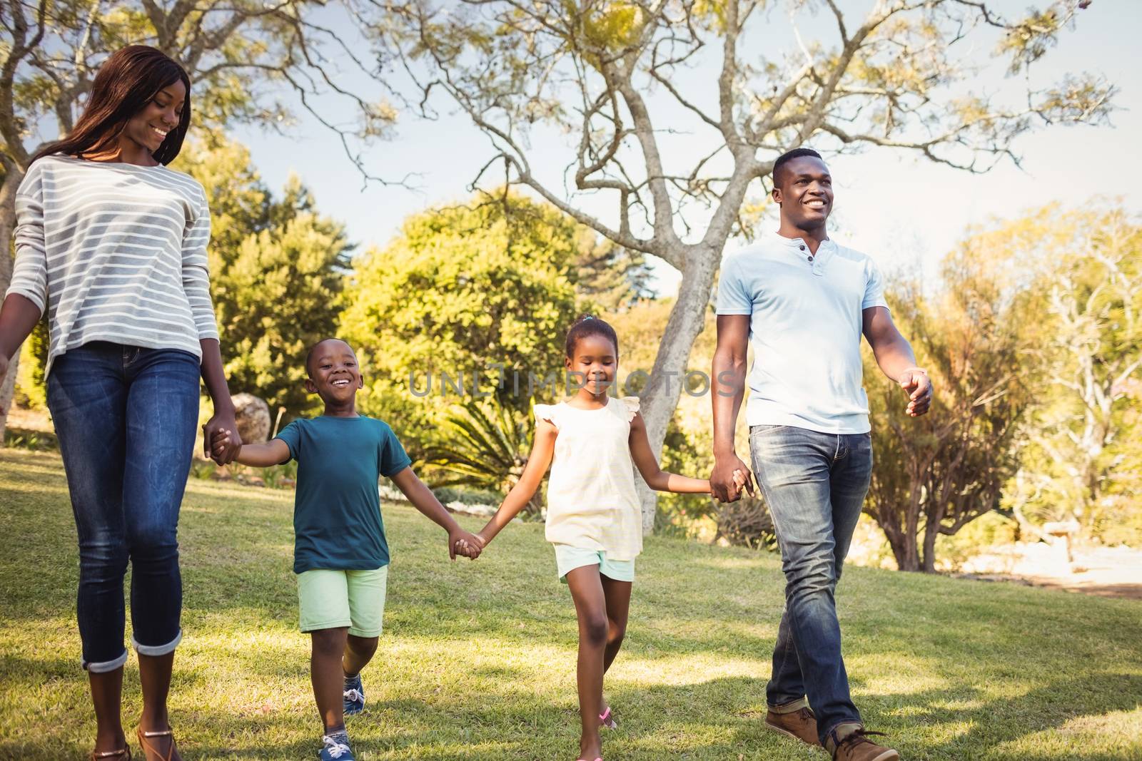 Happy family walking together by Wavebreakmedia