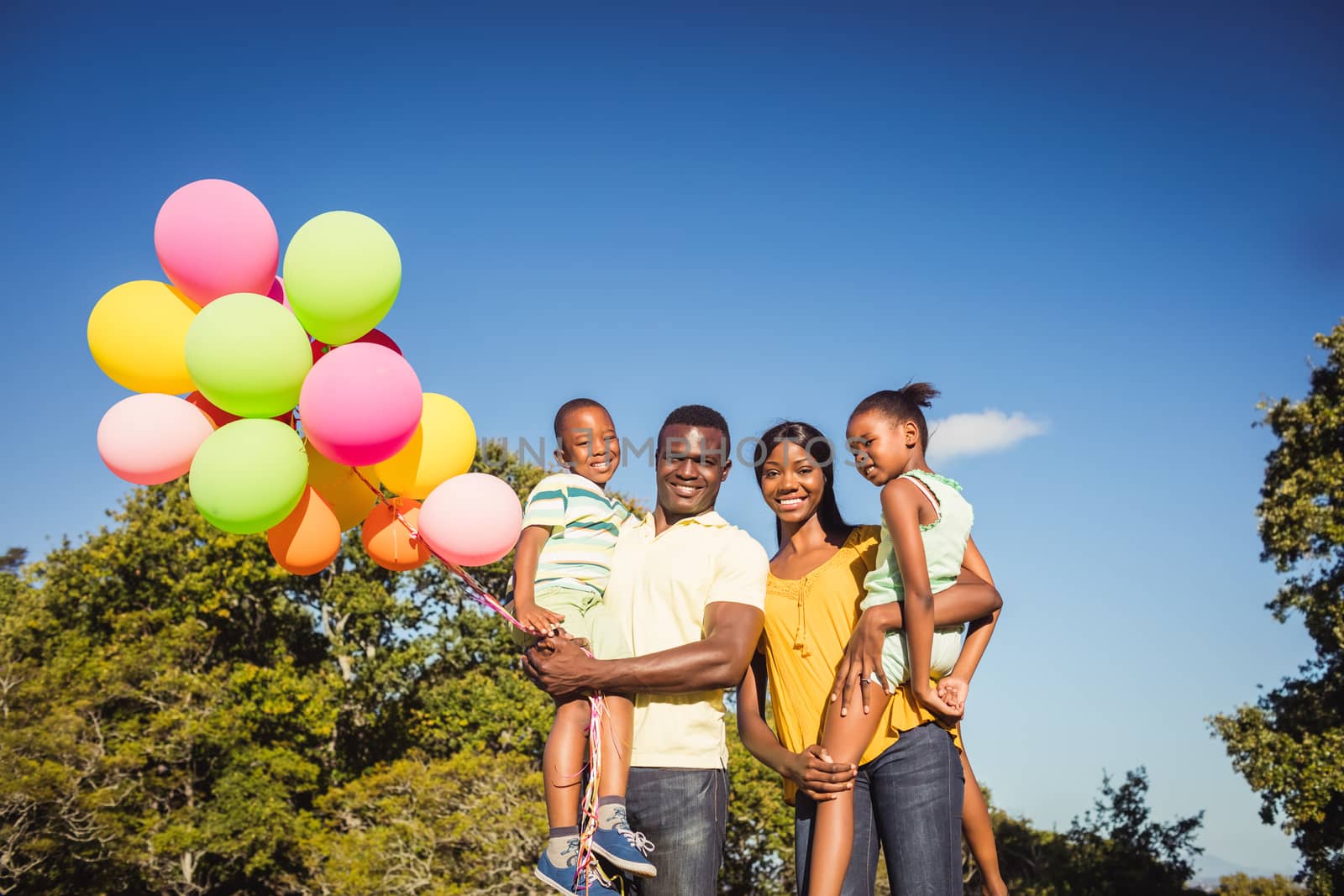 Happy family posing together at park