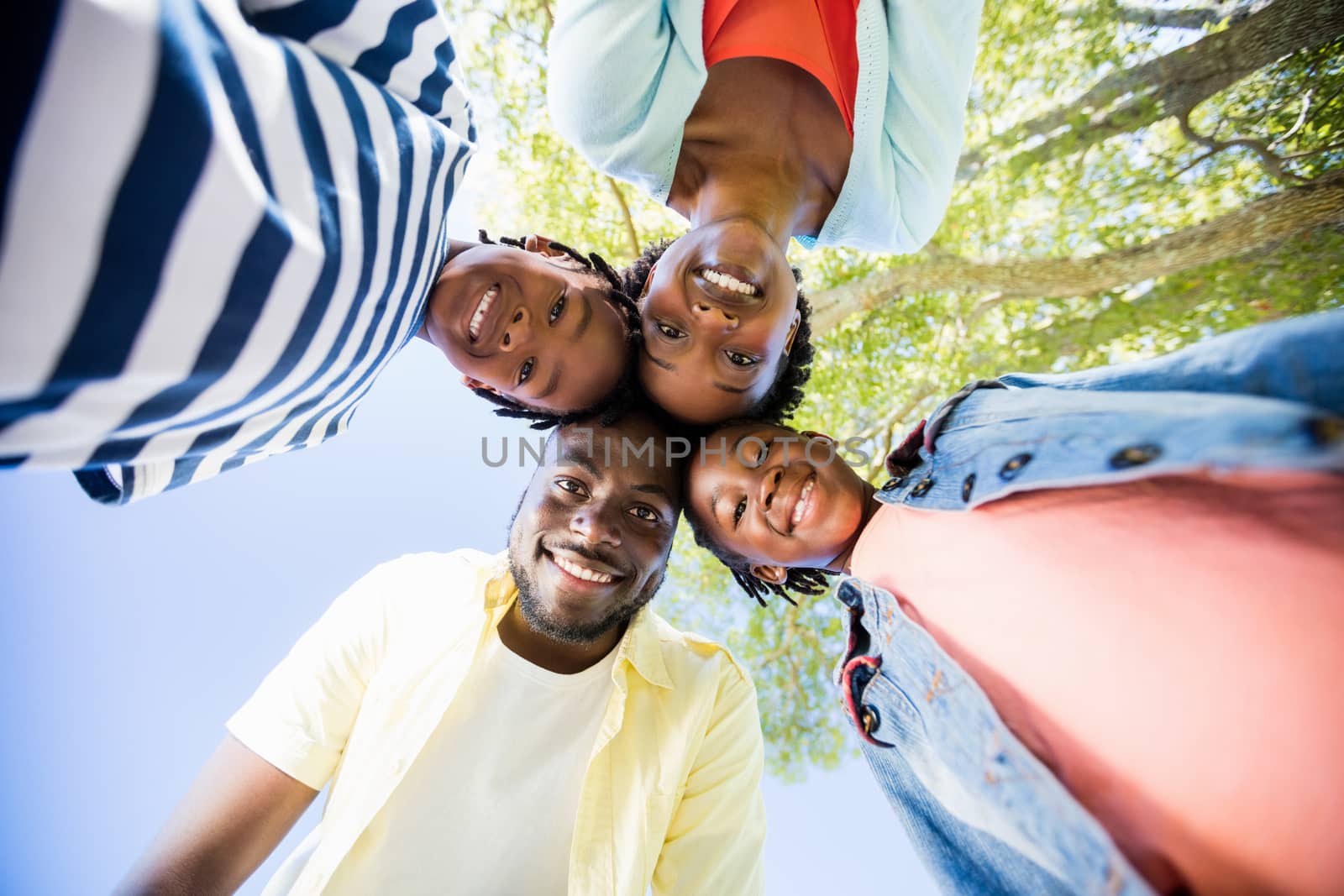 Happy family posing together at park