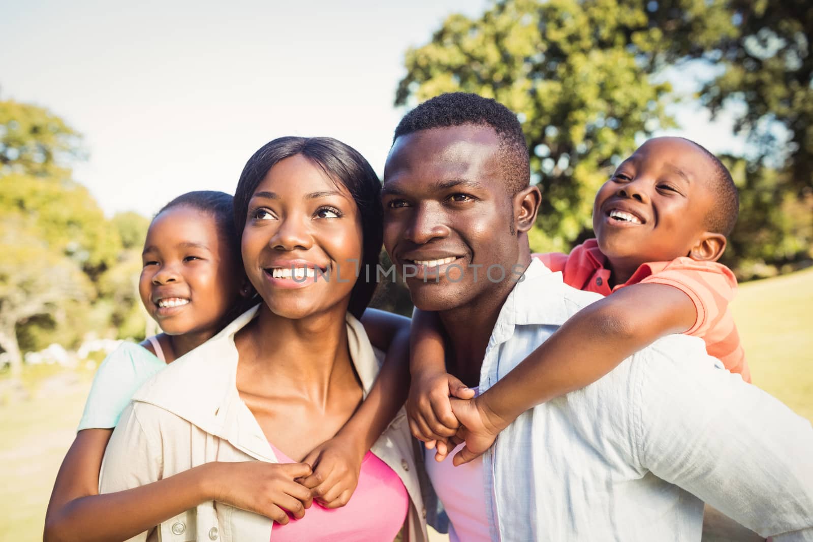 Happy family posing together at park