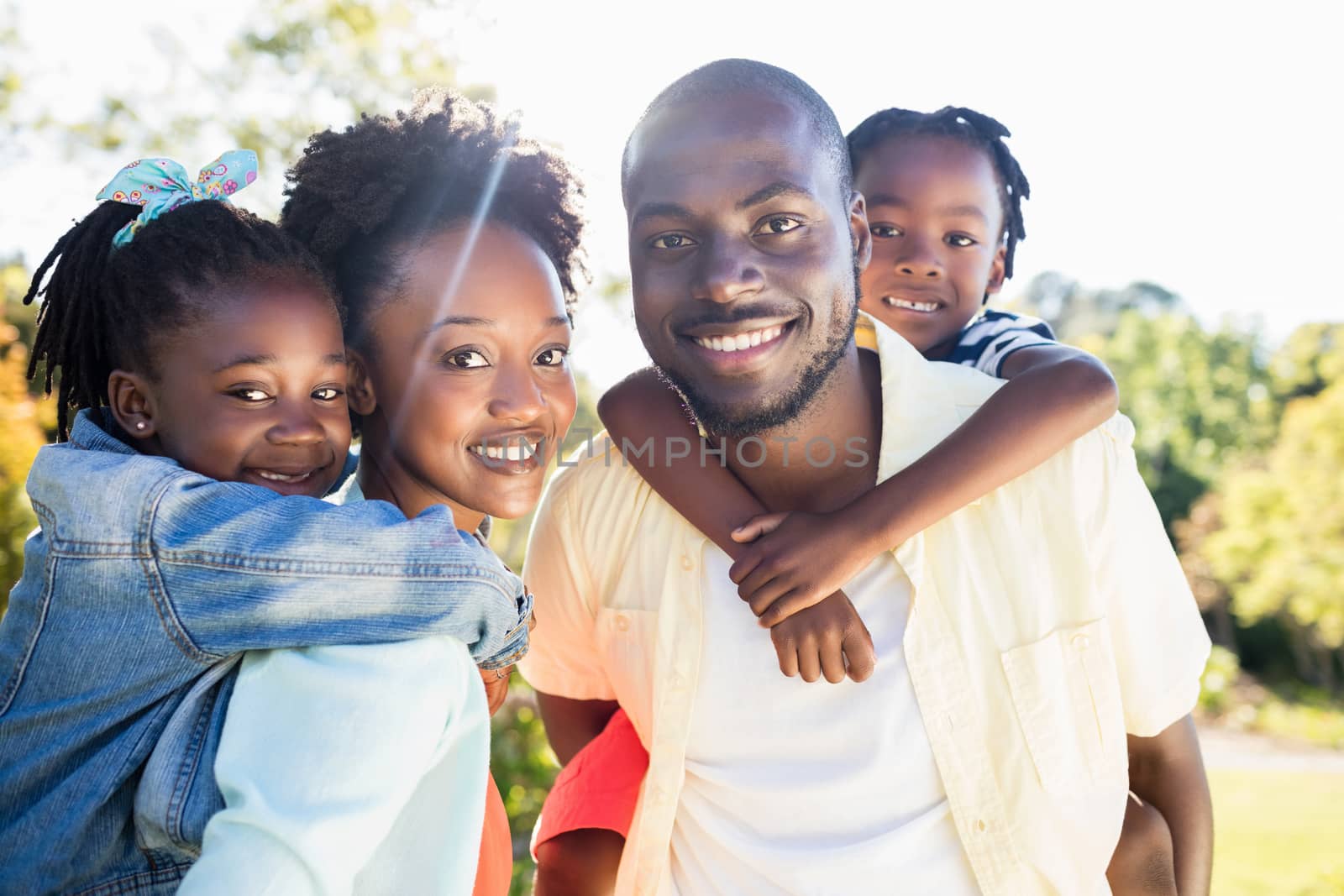 Happy family posing together at park