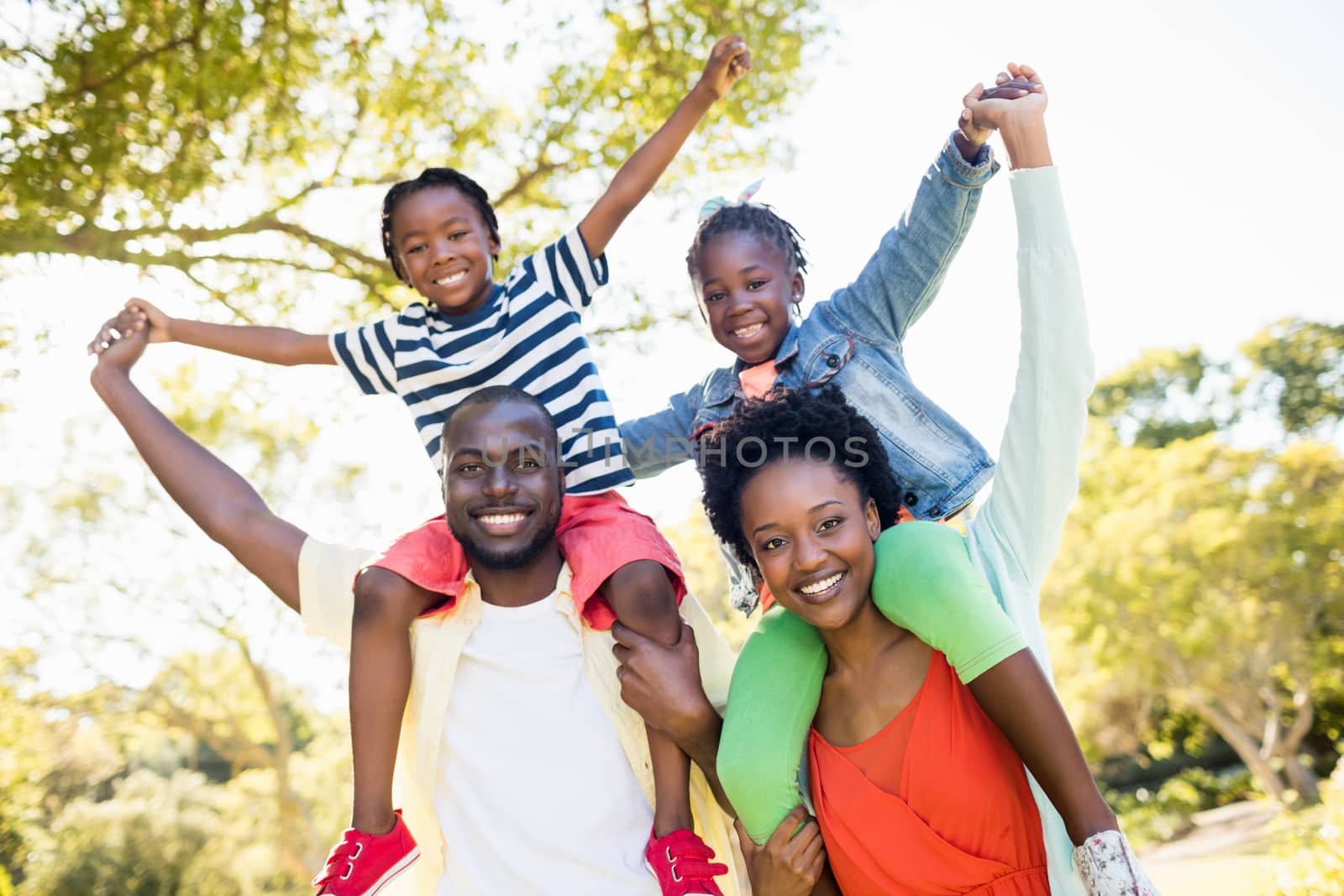 Happy family posing together at park