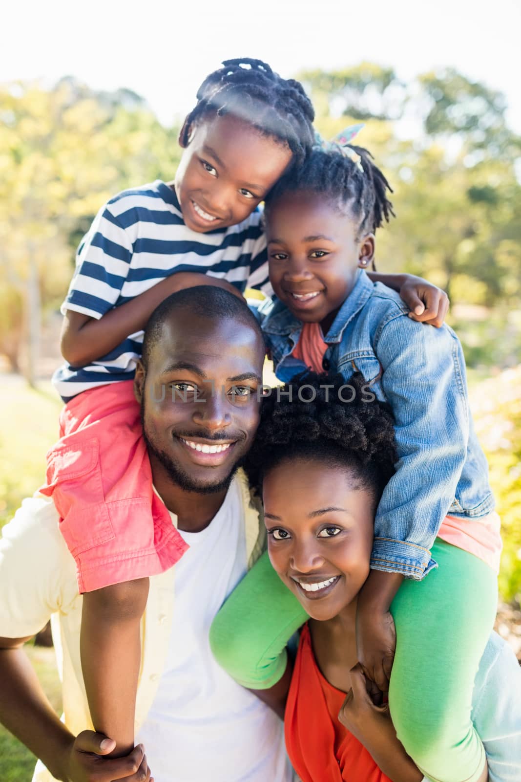 Happy family posing together at park