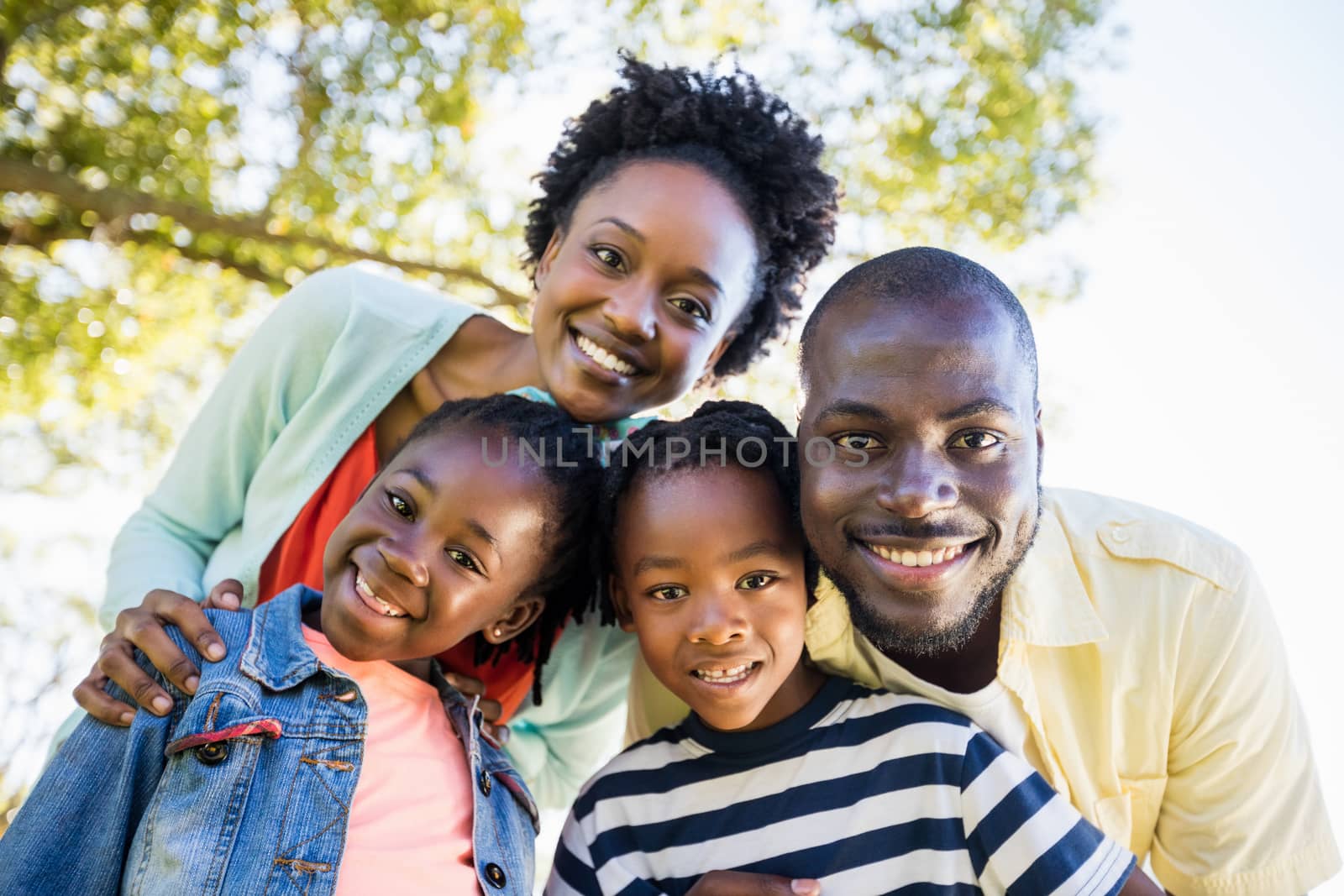 Happy family posing together by Wavebreakmedia