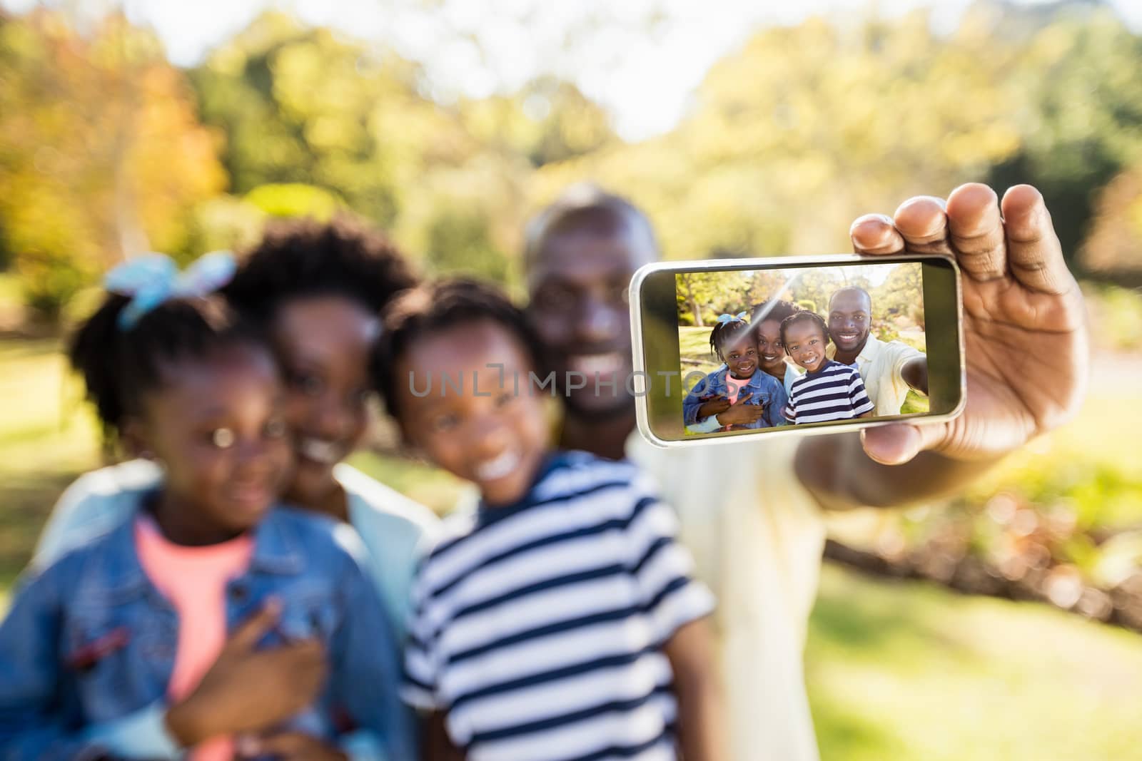 Happy family posing together at park