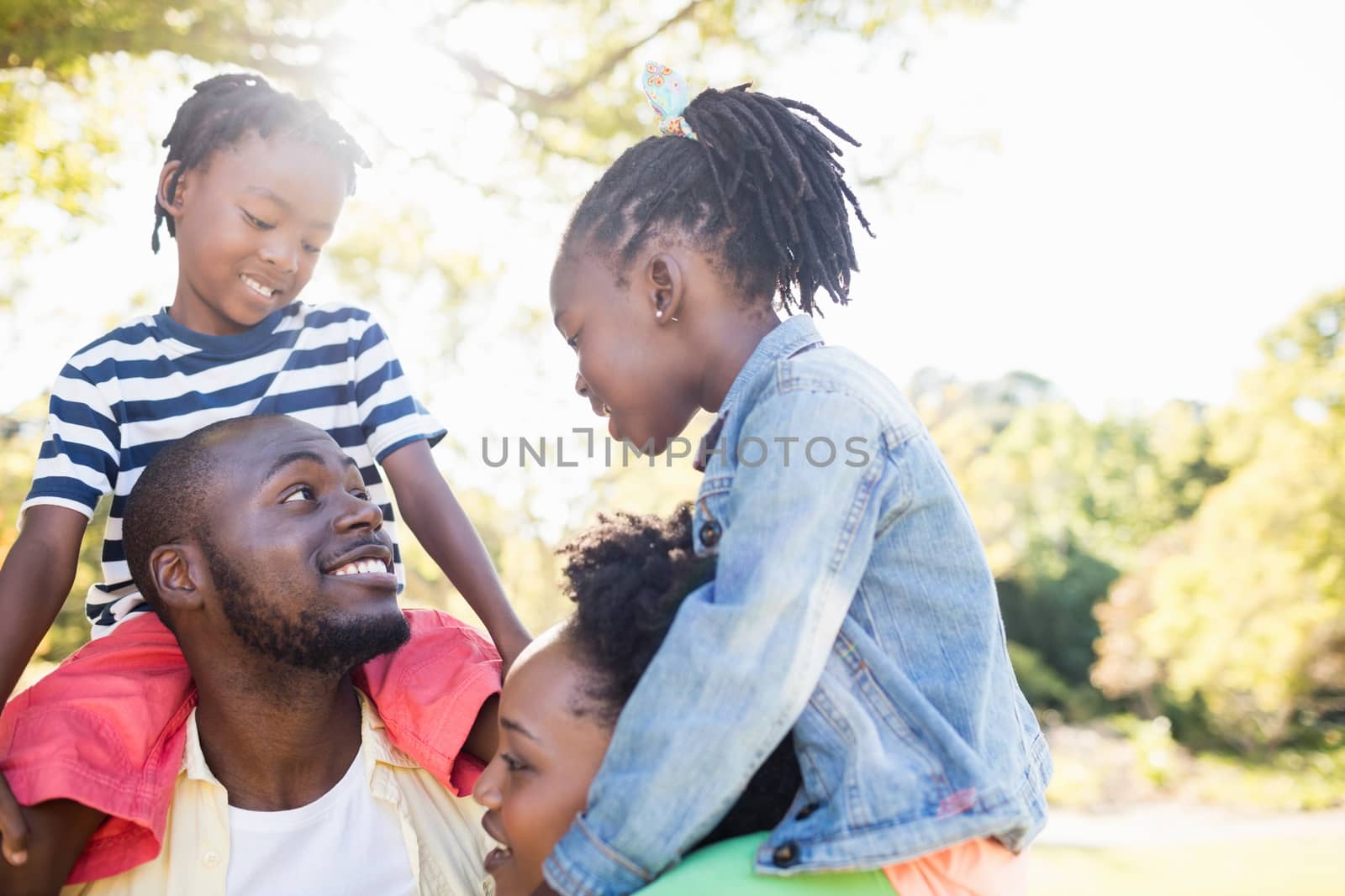 Happy family posing together at park