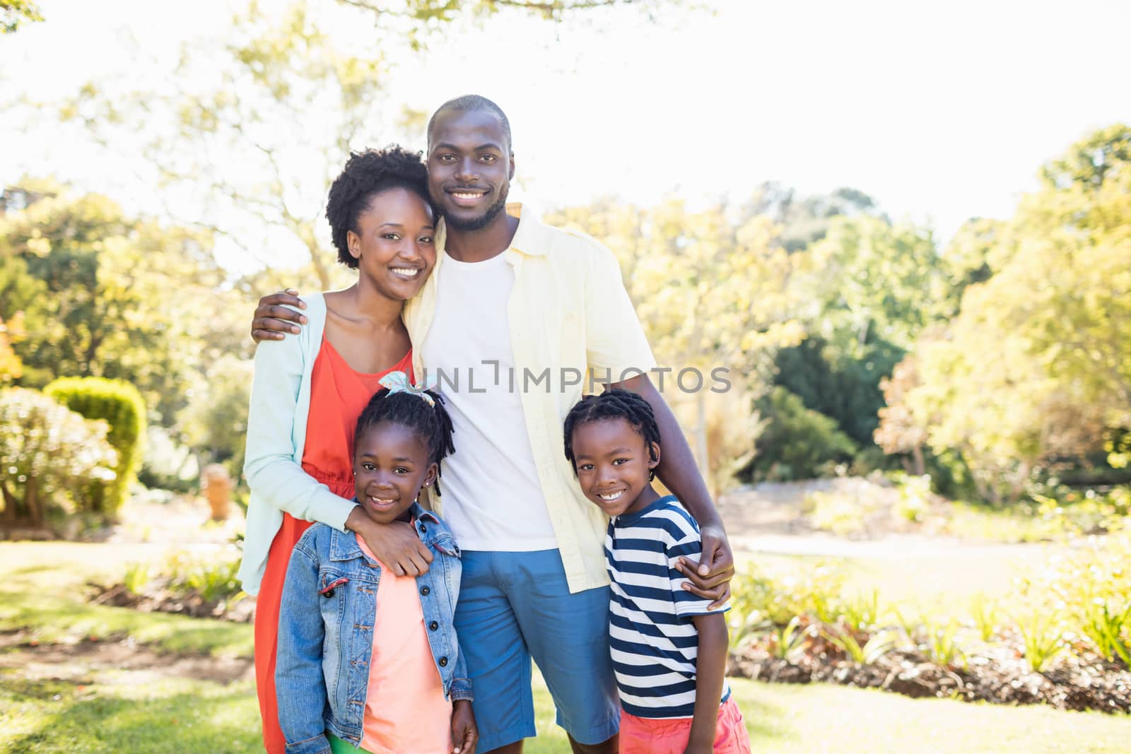 Happy family posing together at park