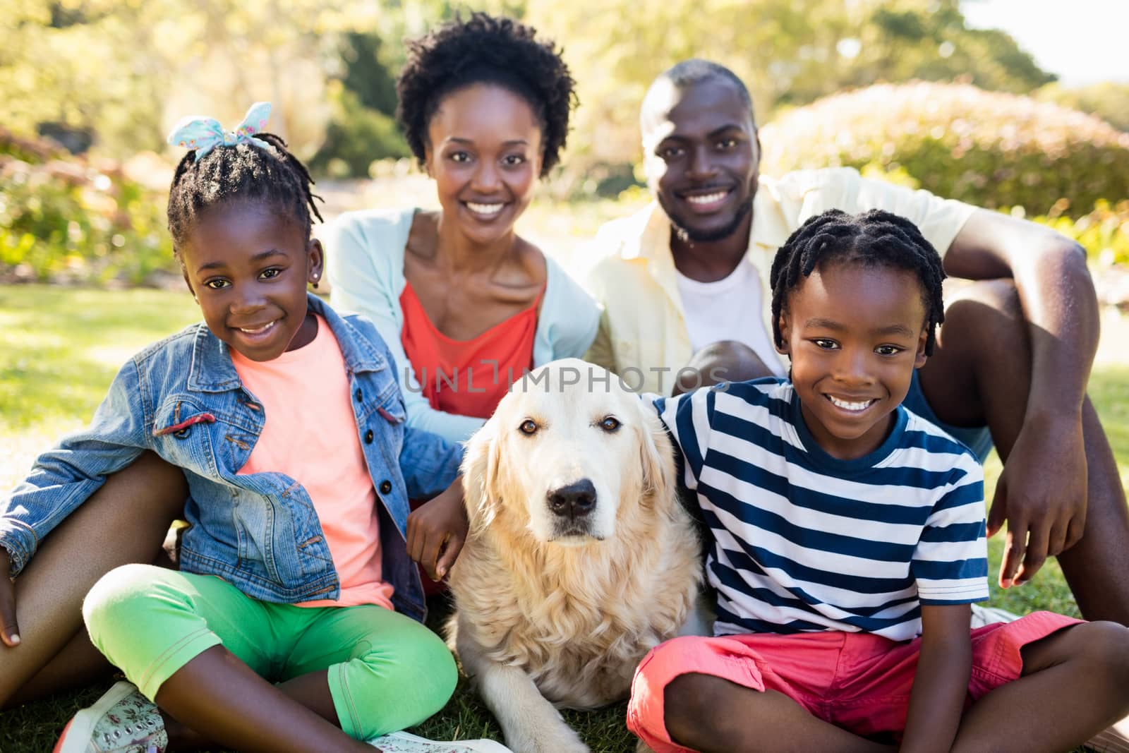 Happy family posing together at park