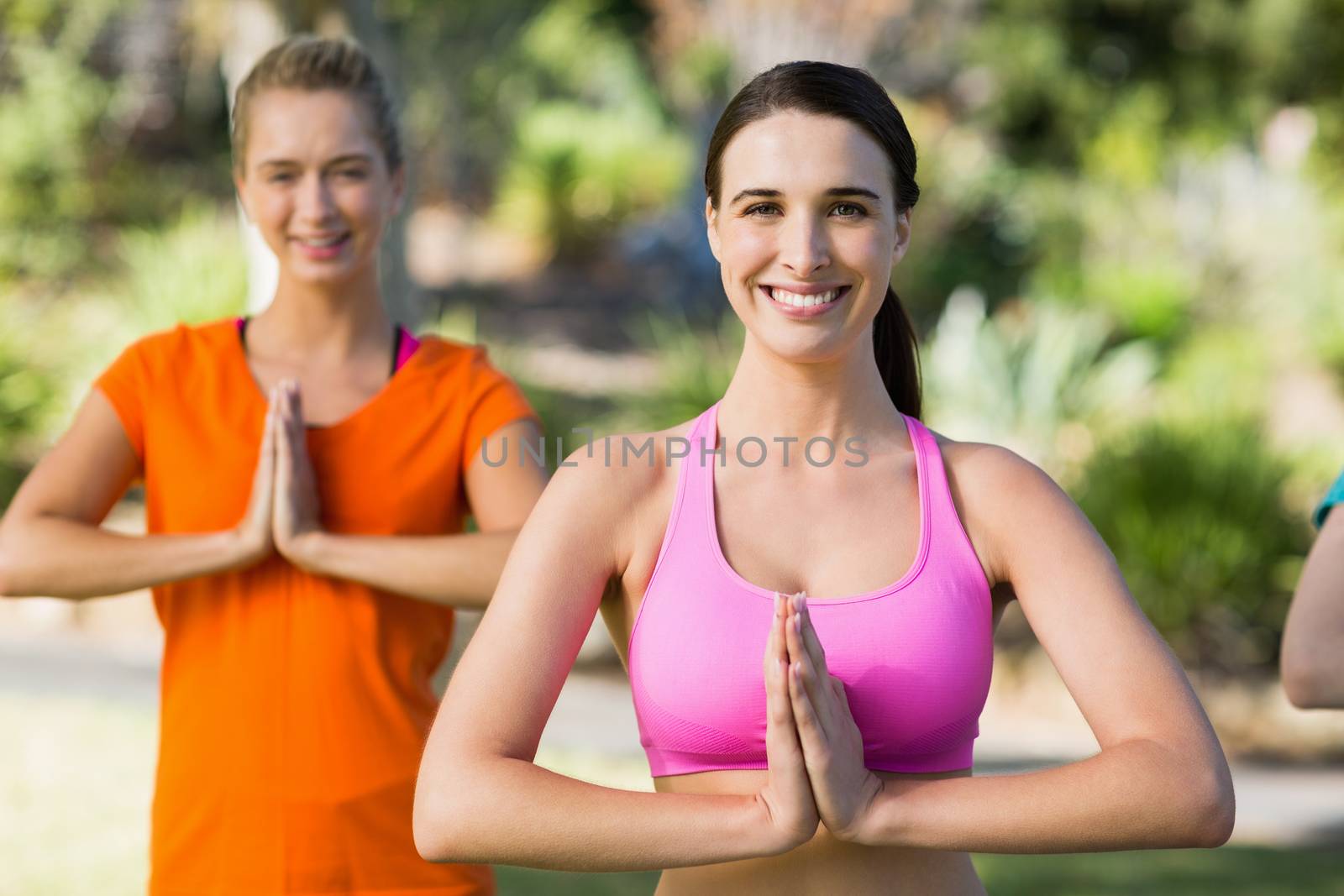 Beautiful women practicing yoga in park
