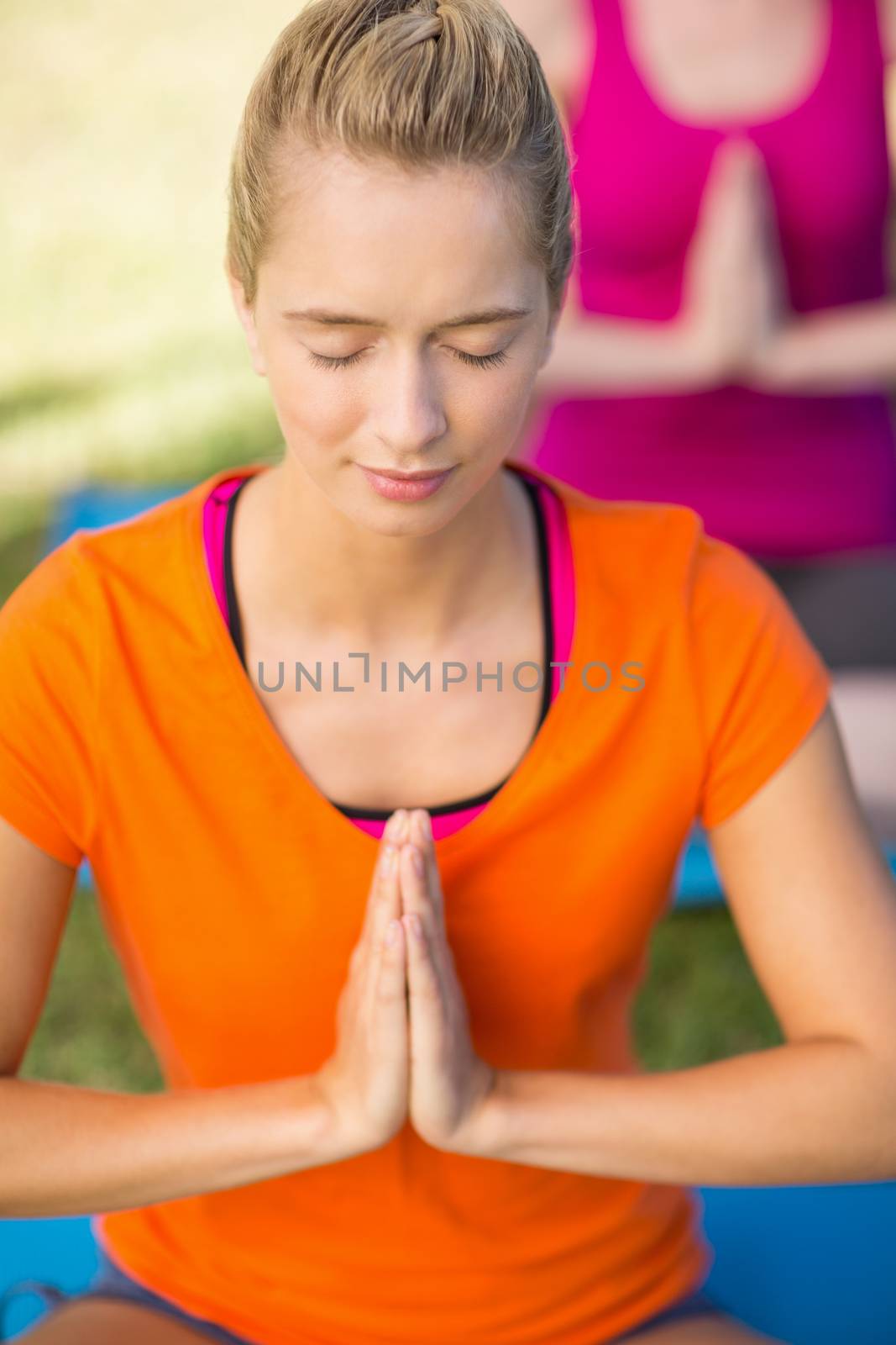 Close-up of beautiful woman practicing yoga in park