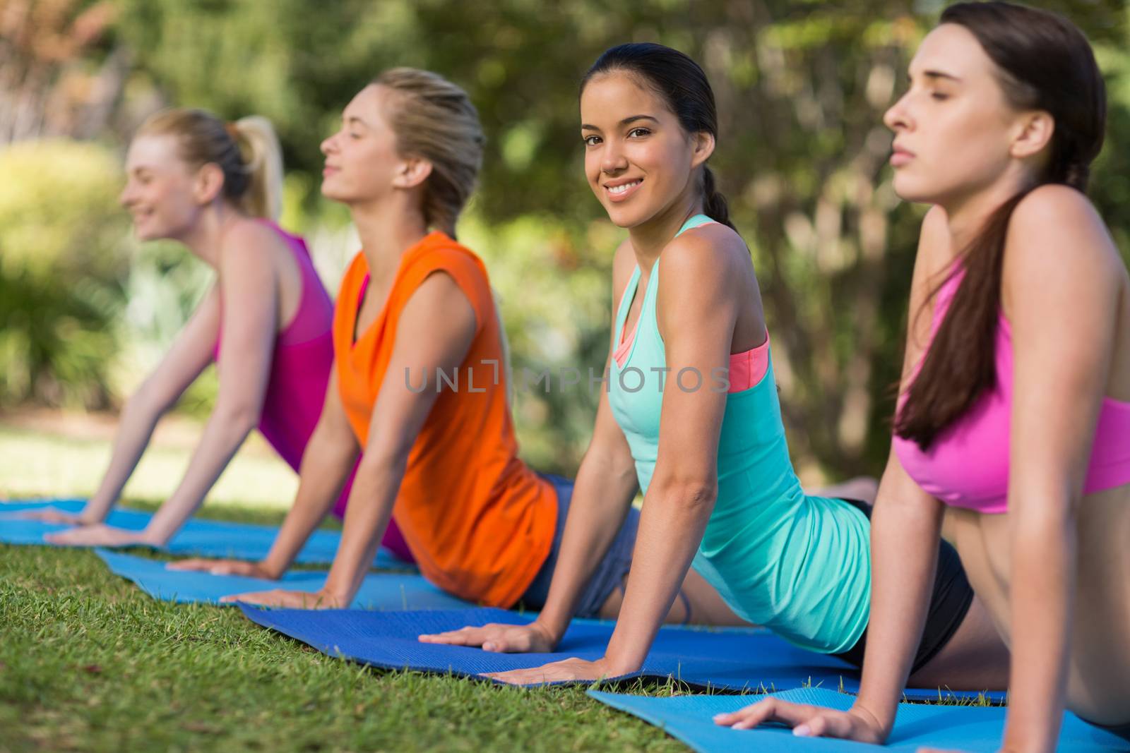 Beautiful women practicing yoga in park