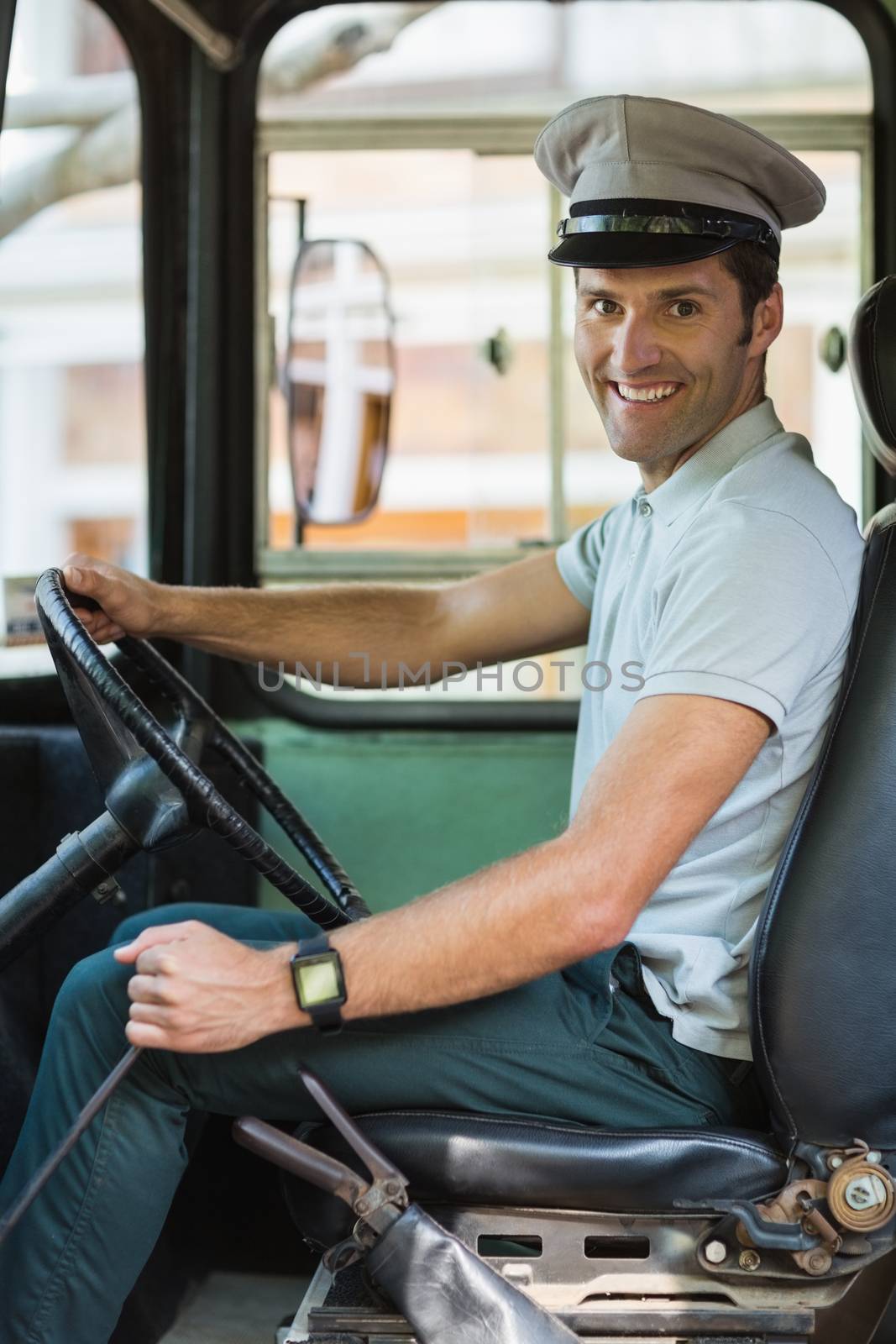 Portrait of smiling bus driver driving a bus
