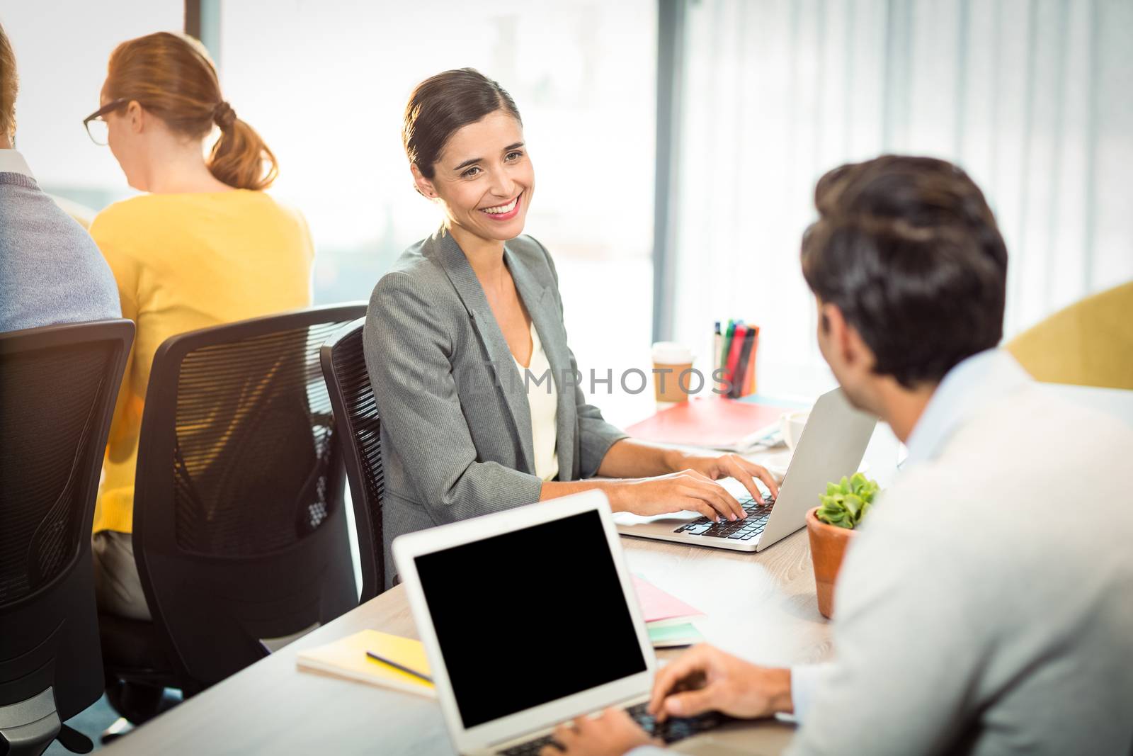 Business people working on laptop in office