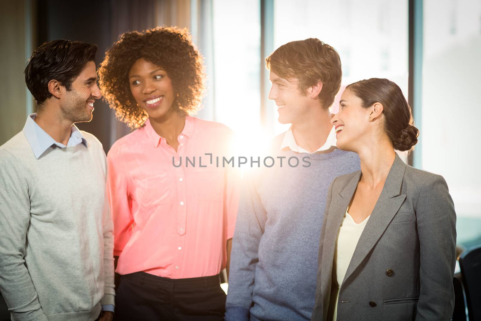 Business people having discussion with each other in office 