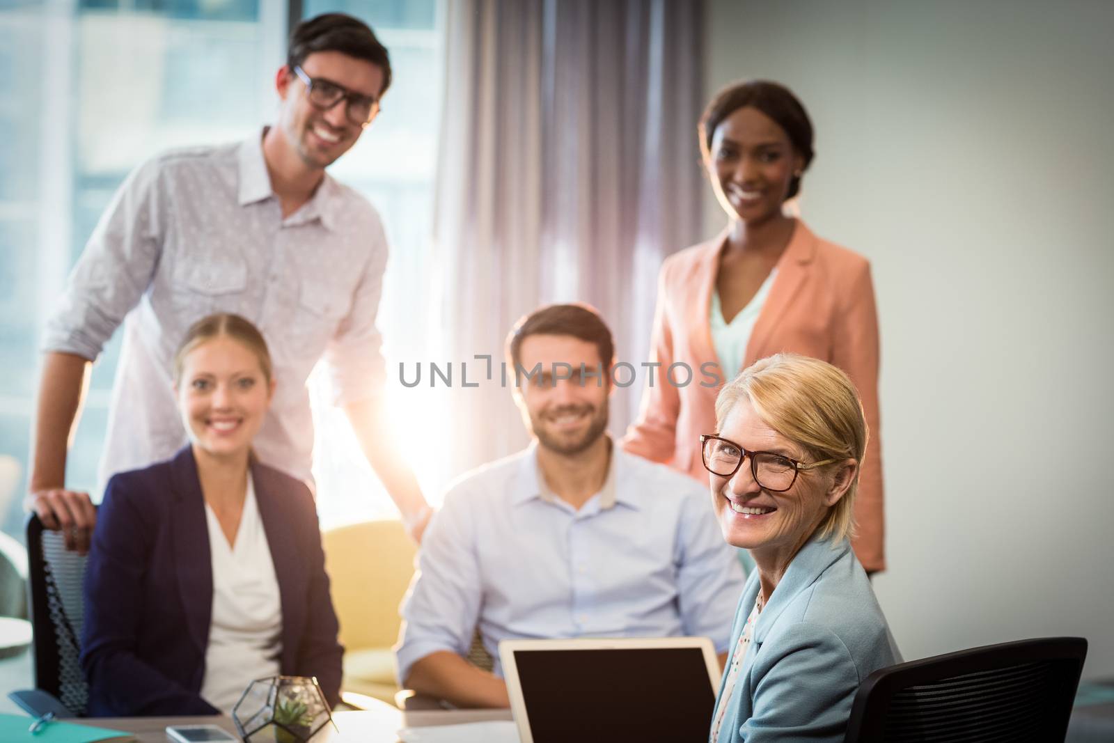 Portrait of business people sitting at desk in the office