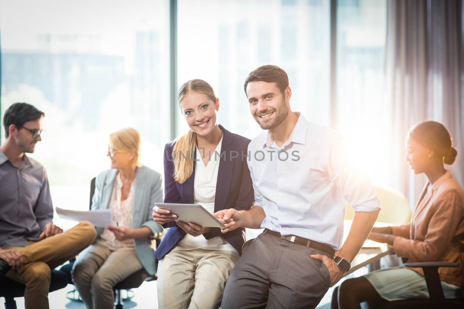Business people interacting with each other by Wavebreakmedia