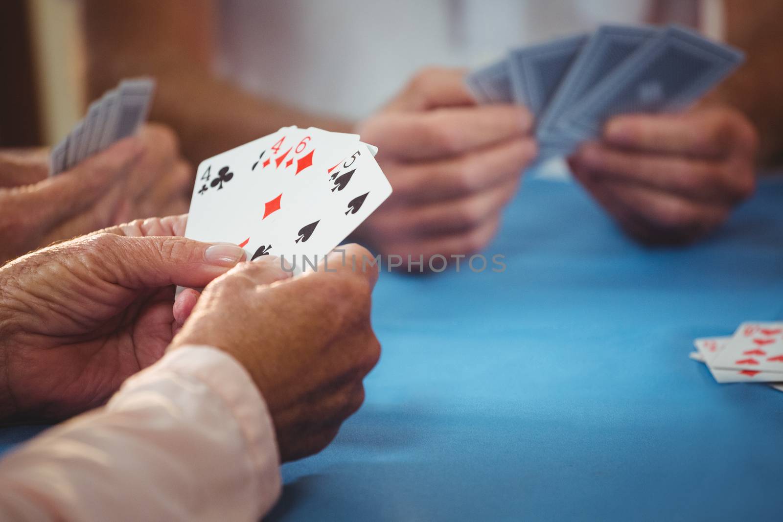 Retired people playing card by Wavebreakmedia