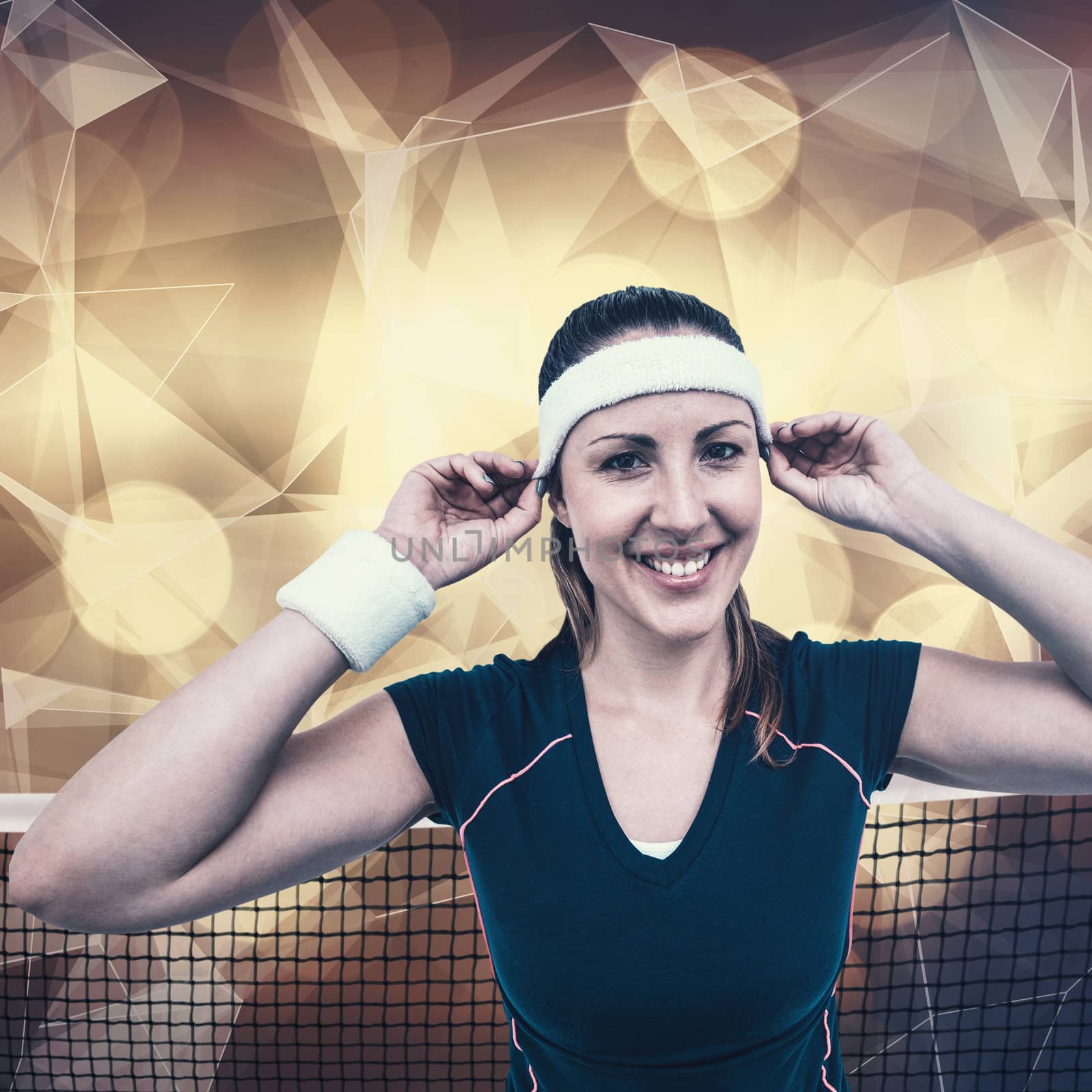 Female athlete wearing headband and wristband against lights as a background