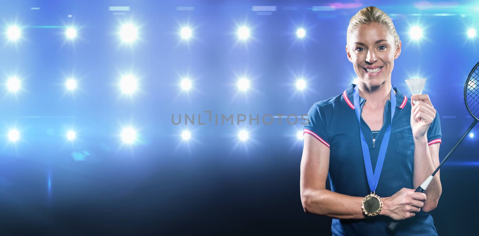 Badminton player posing with gold medal around her neck against composite image of blue spotlight