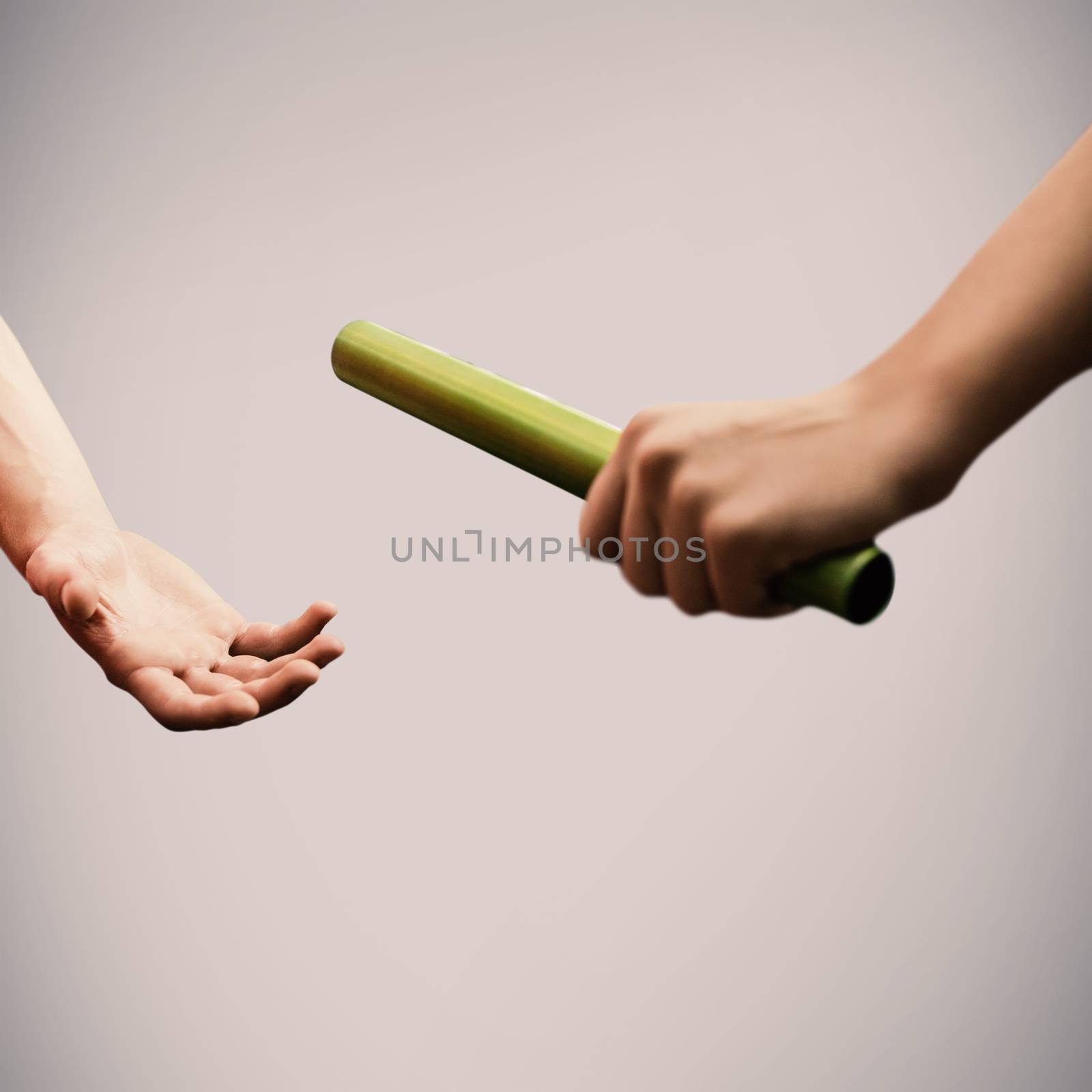 Athlete passing a baton to the partner