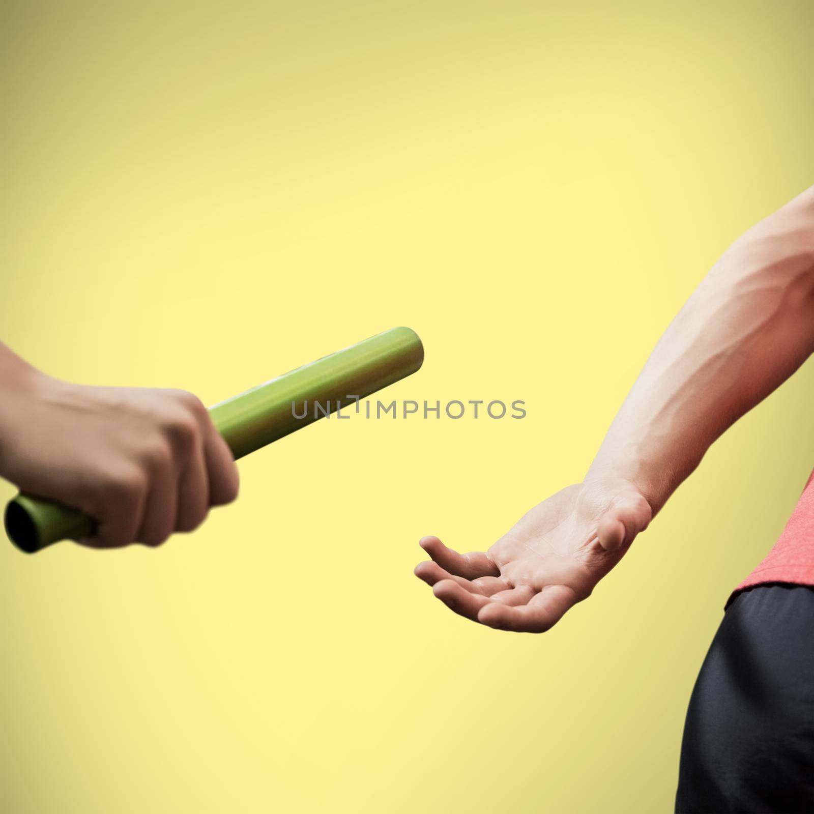 Athlete passing a baton to the partner on yellow background