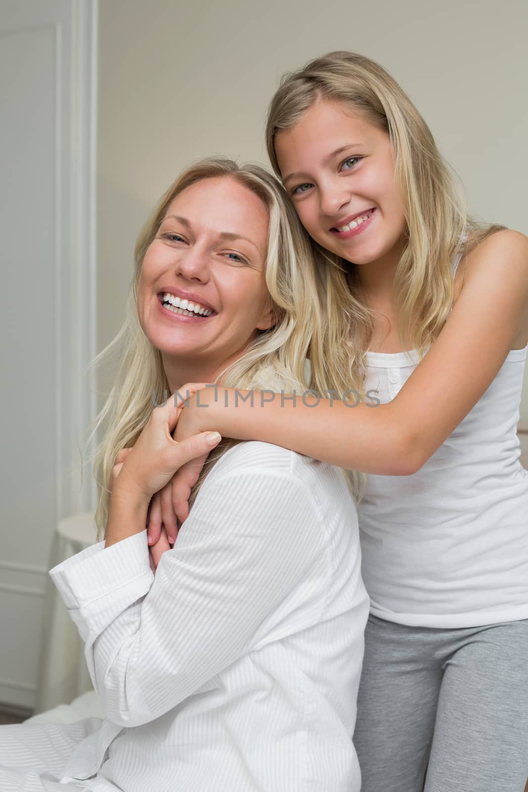 Portrait of loving girl with mother in house