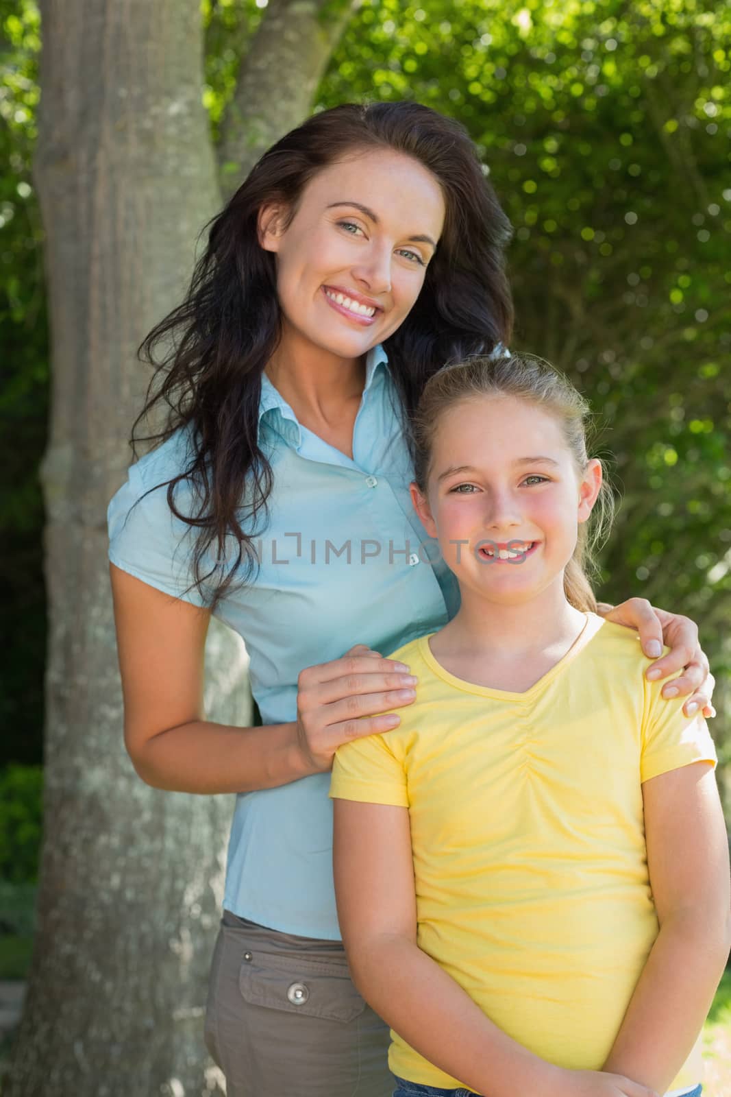 Happy mother and daughter standing in park by Wavebreakmedia