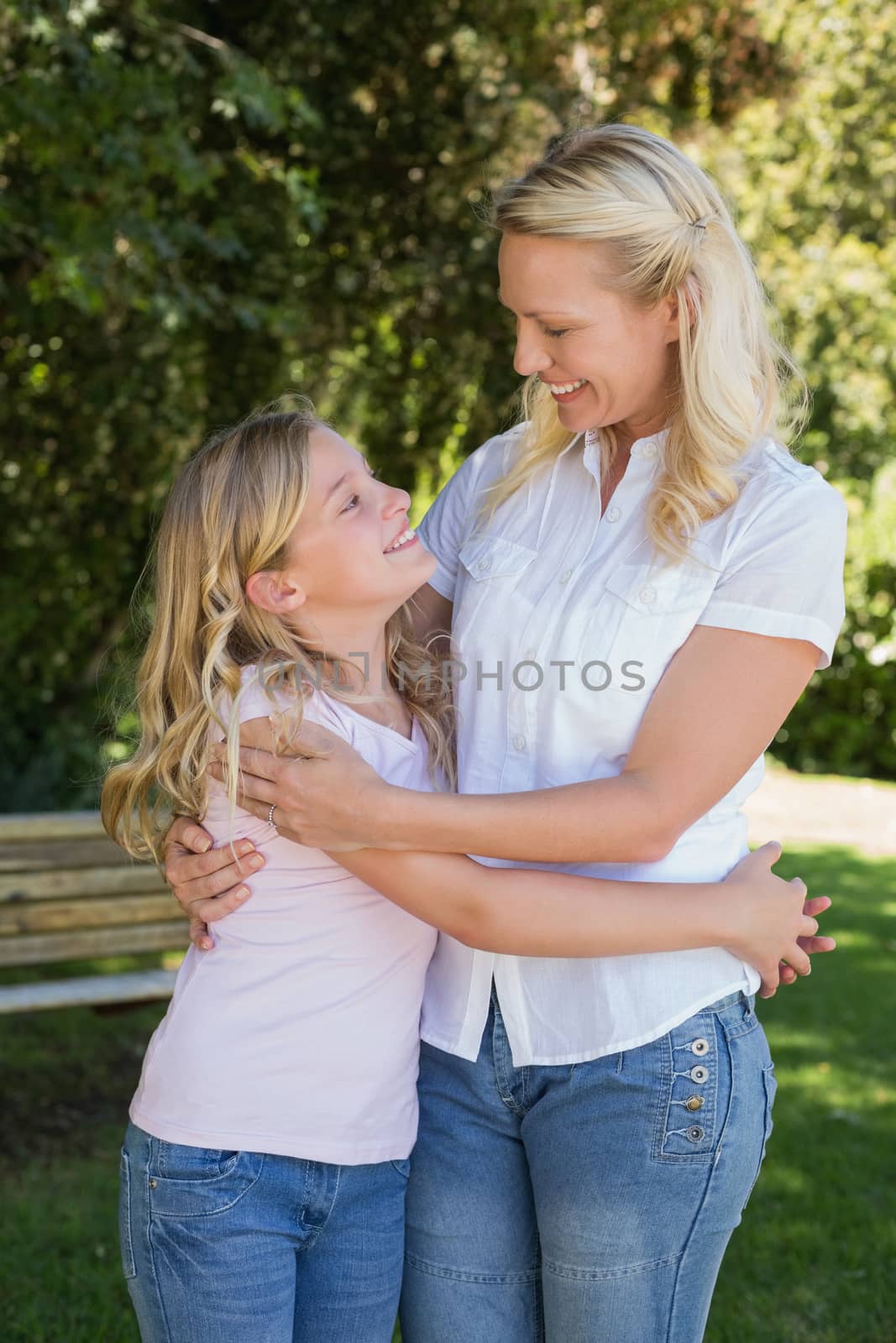 Happy mother and daughter embracing in park by Wavebreakmedia