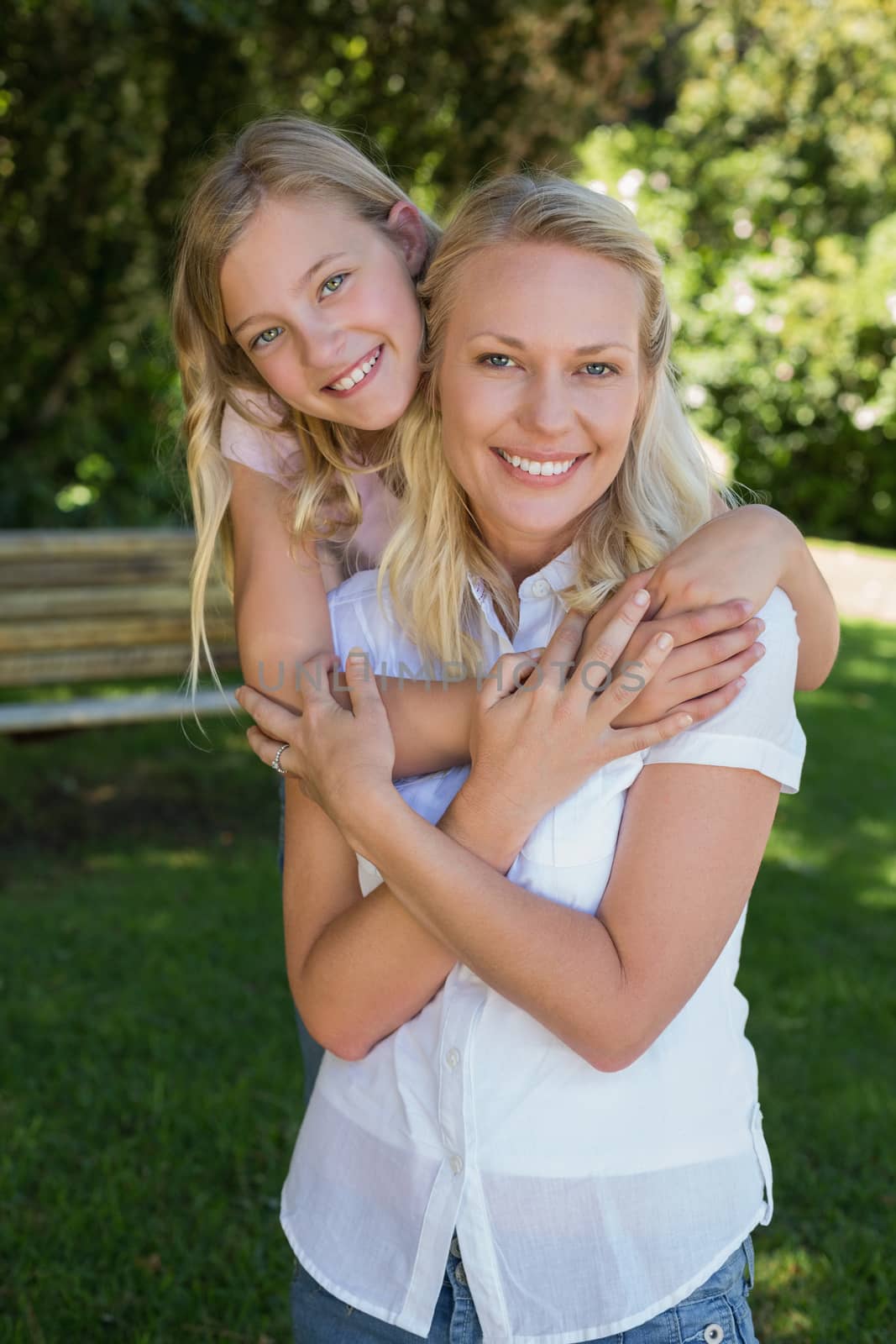 Girl embracing mother from behind in park by Wavebreakmedia