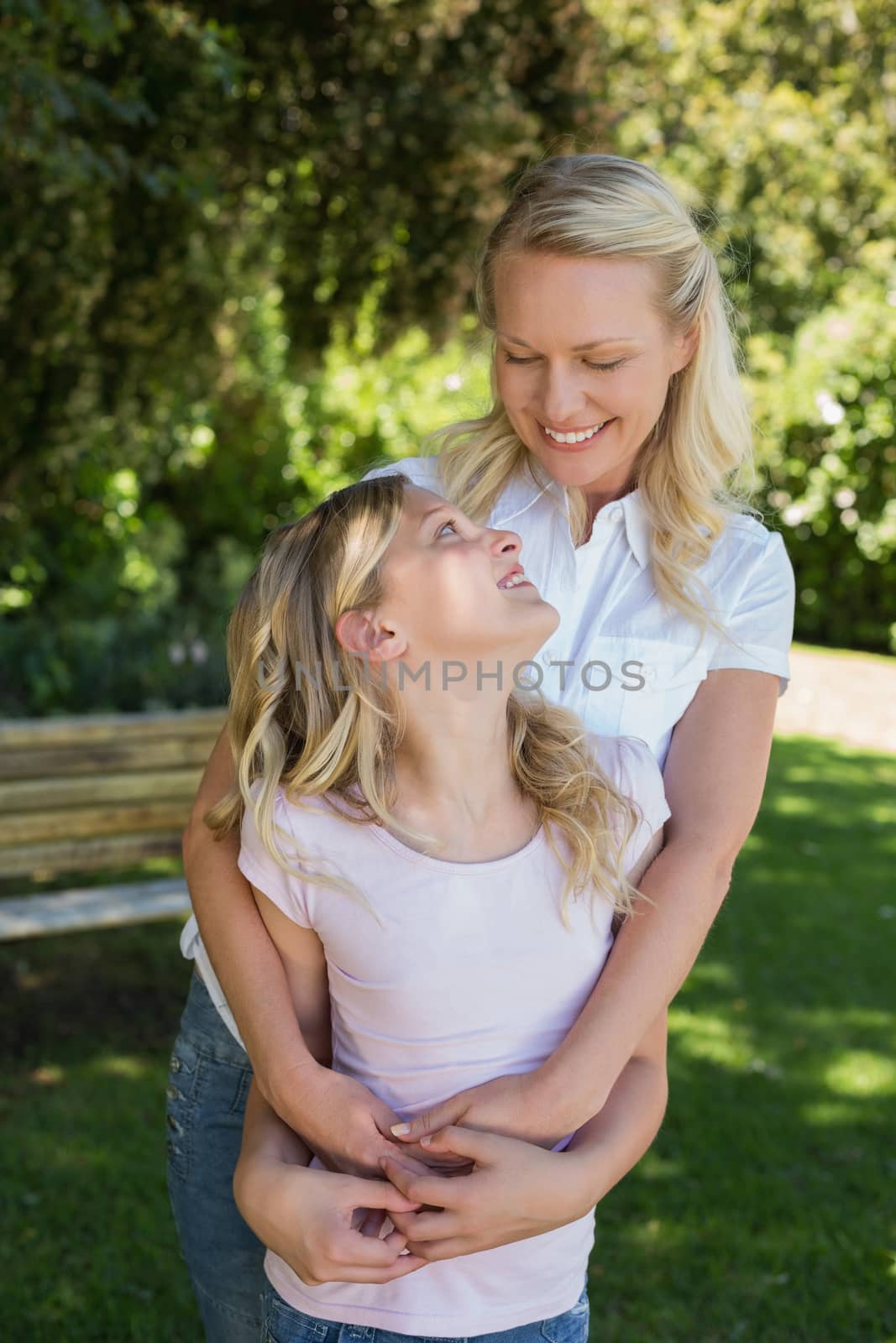 Loving mother and daughter looking at each other in park by Wavebreakmedia
