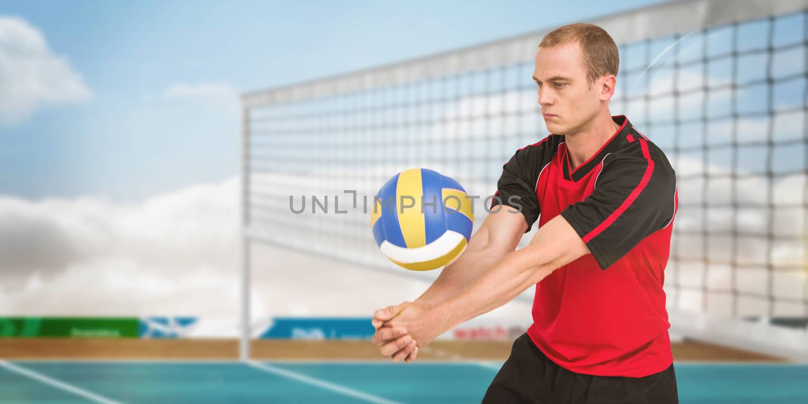 Sportsman playing a volleyball against view of a coloured background
