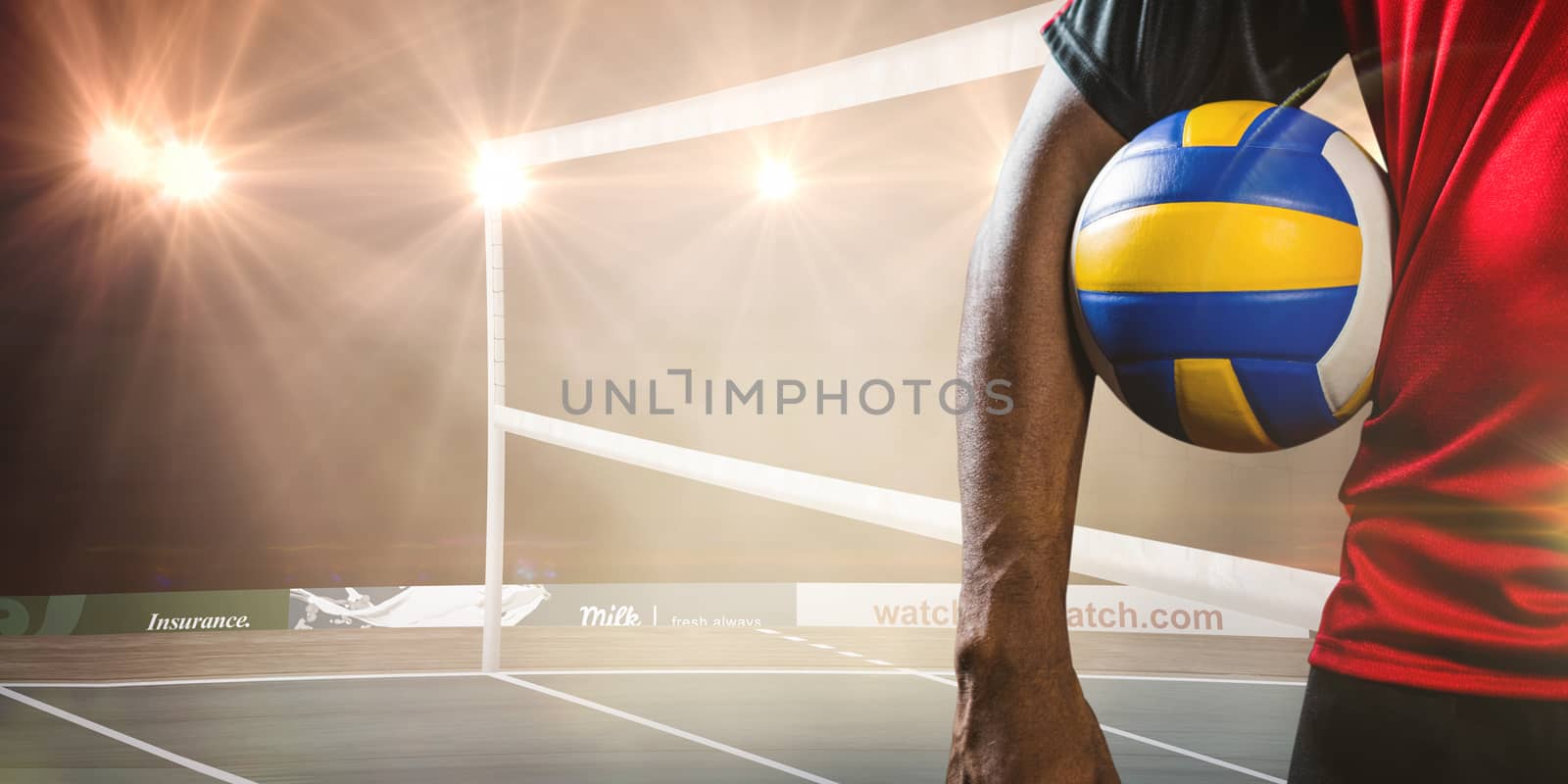 Mid-section of sportsman holding a volleyball against view of orange background