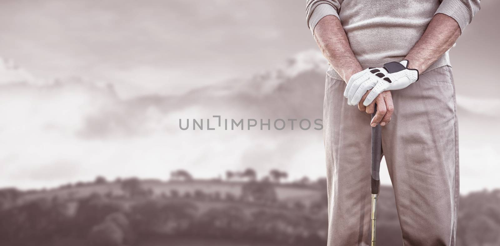 Golf player posing against country scene