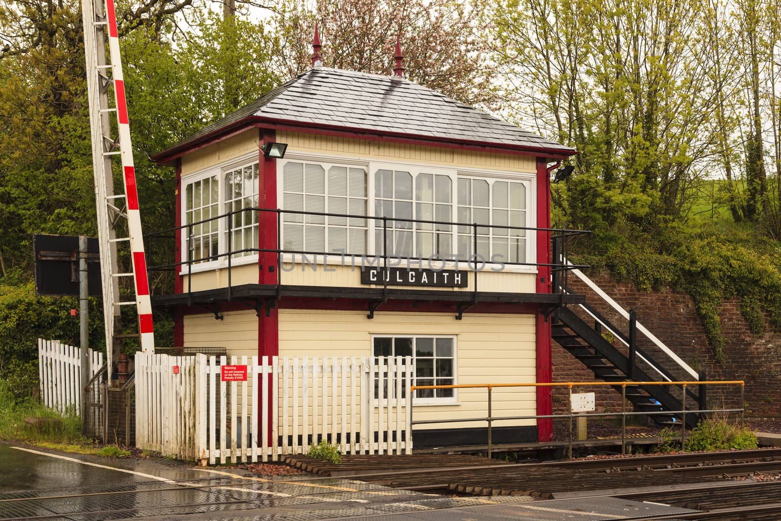 A railway crossing and traditional railway signal box at Culgaith on the historic Settle to Carlisle railway in northern England.