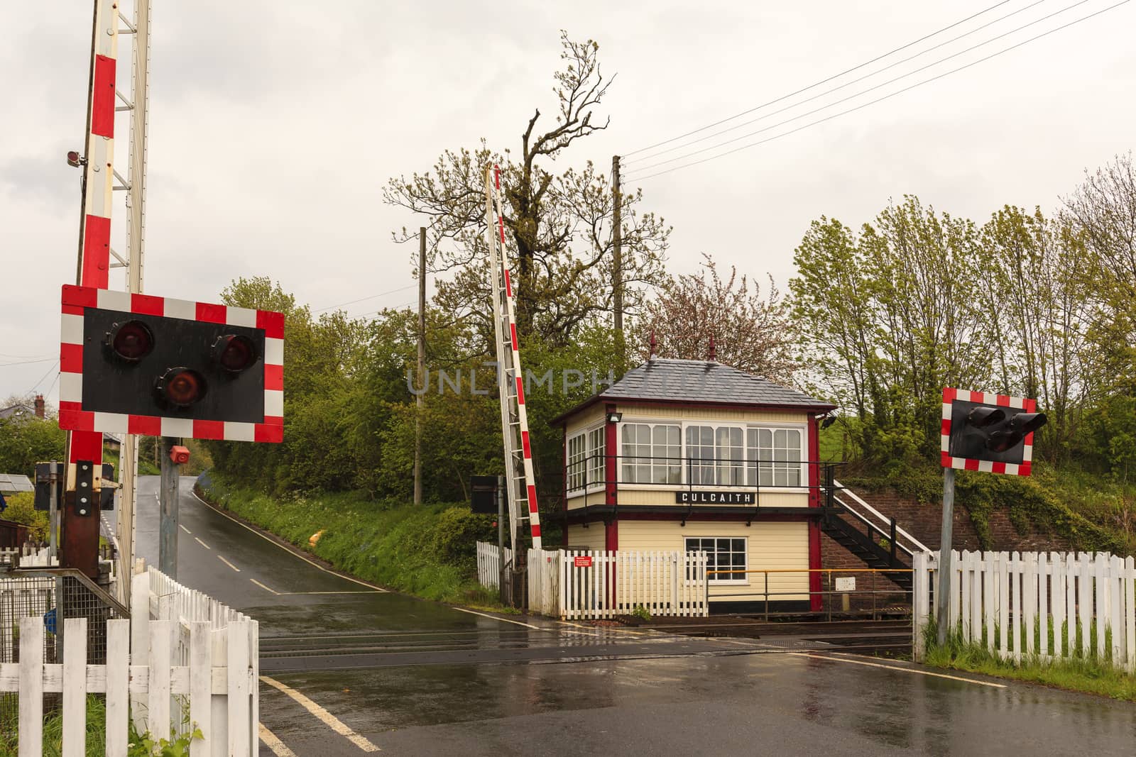 A railway crossing and traditional railway signal box at Culgaith on the historic Settle to Carlisle railway in northern England.