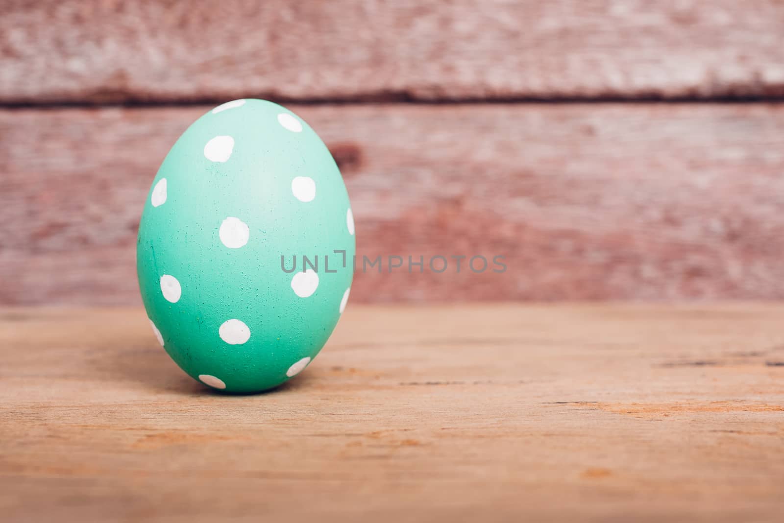 Beautiful Easter Green egg on wooden background, Easter day concept