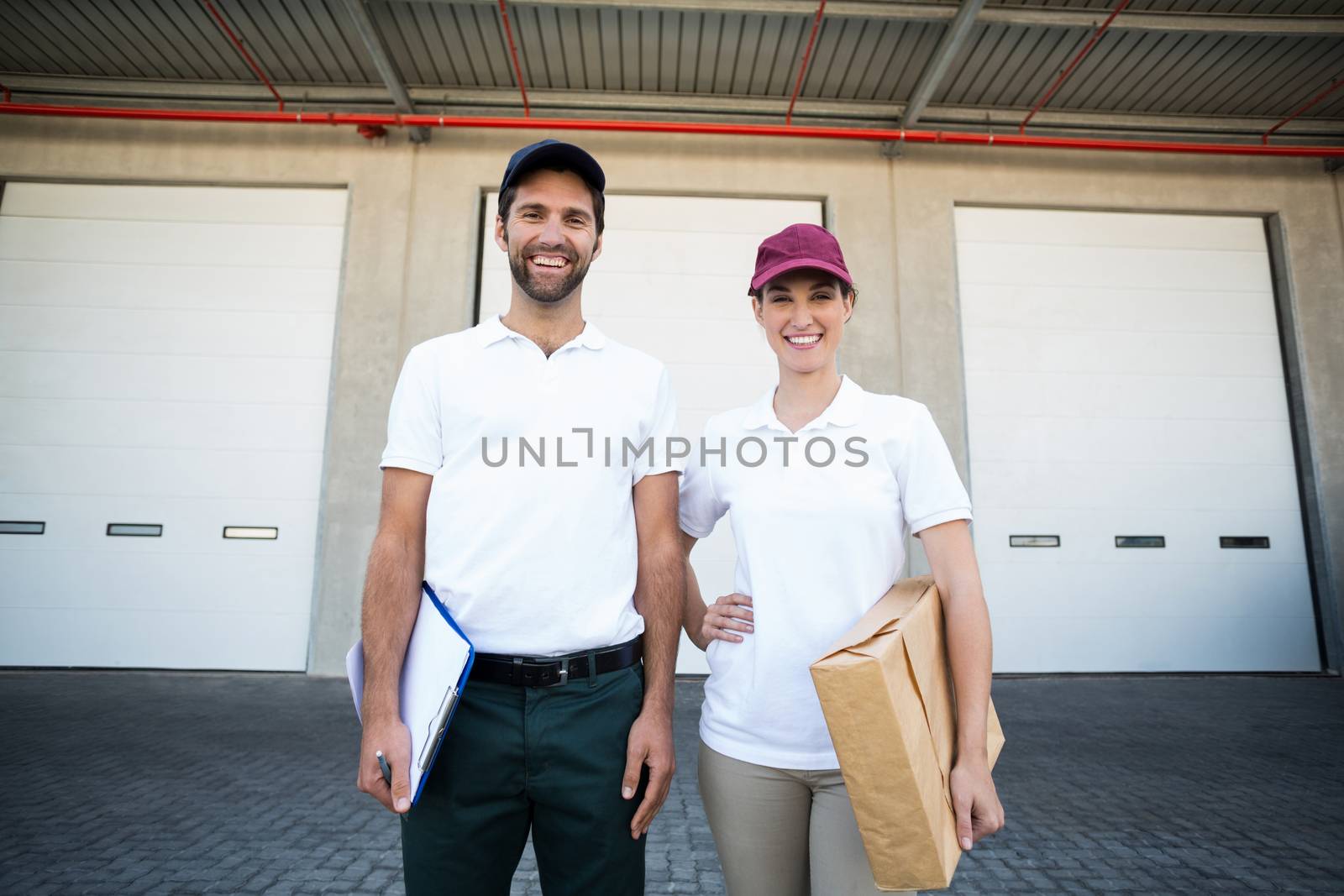 Delivery people are posing and smiling by Wavebreakmedia