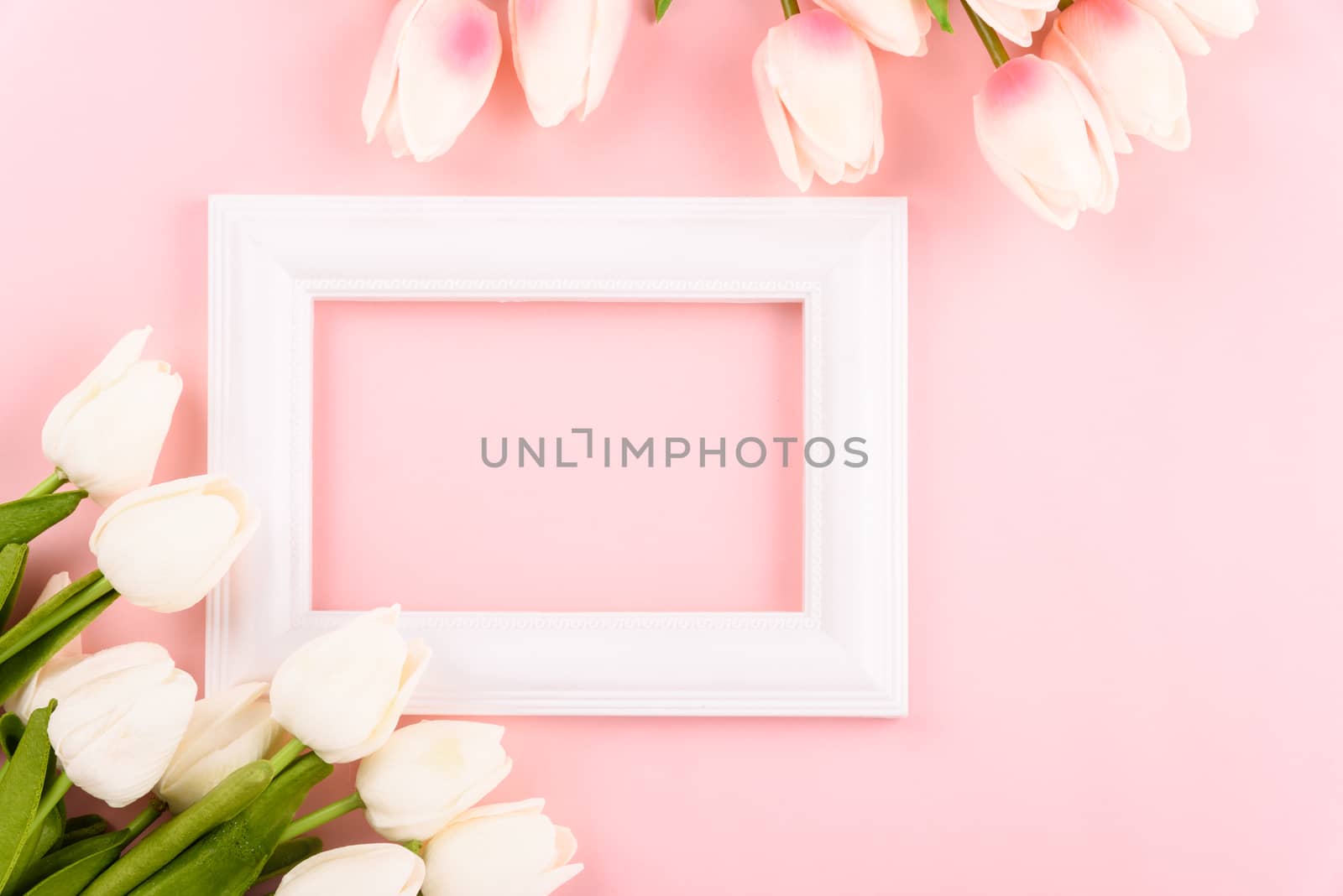 Happy Women's Day, Mother's Day concept. top view flat lay Tulip flower and photo frame on pink background, copy space for your text