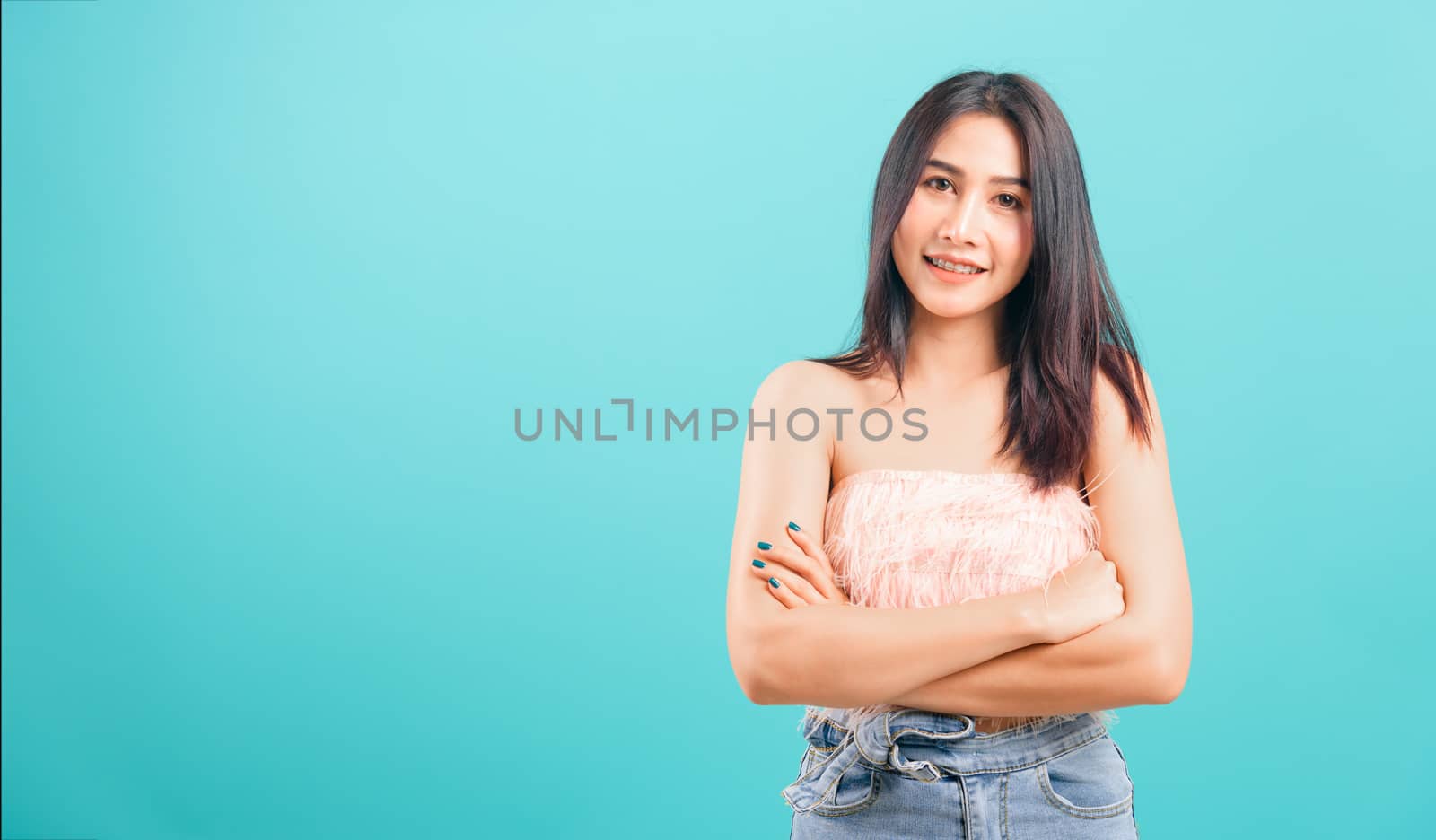 Smiling face asian beautiful woman her crossed arms looking to c by Sorapop