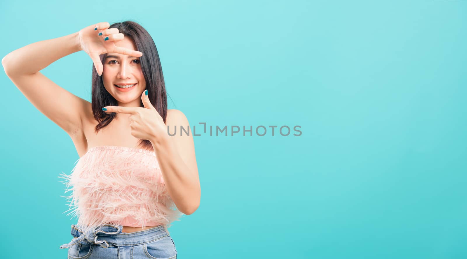 Smiling face asian beautiful woman her showing frame finger sign by Sorapop