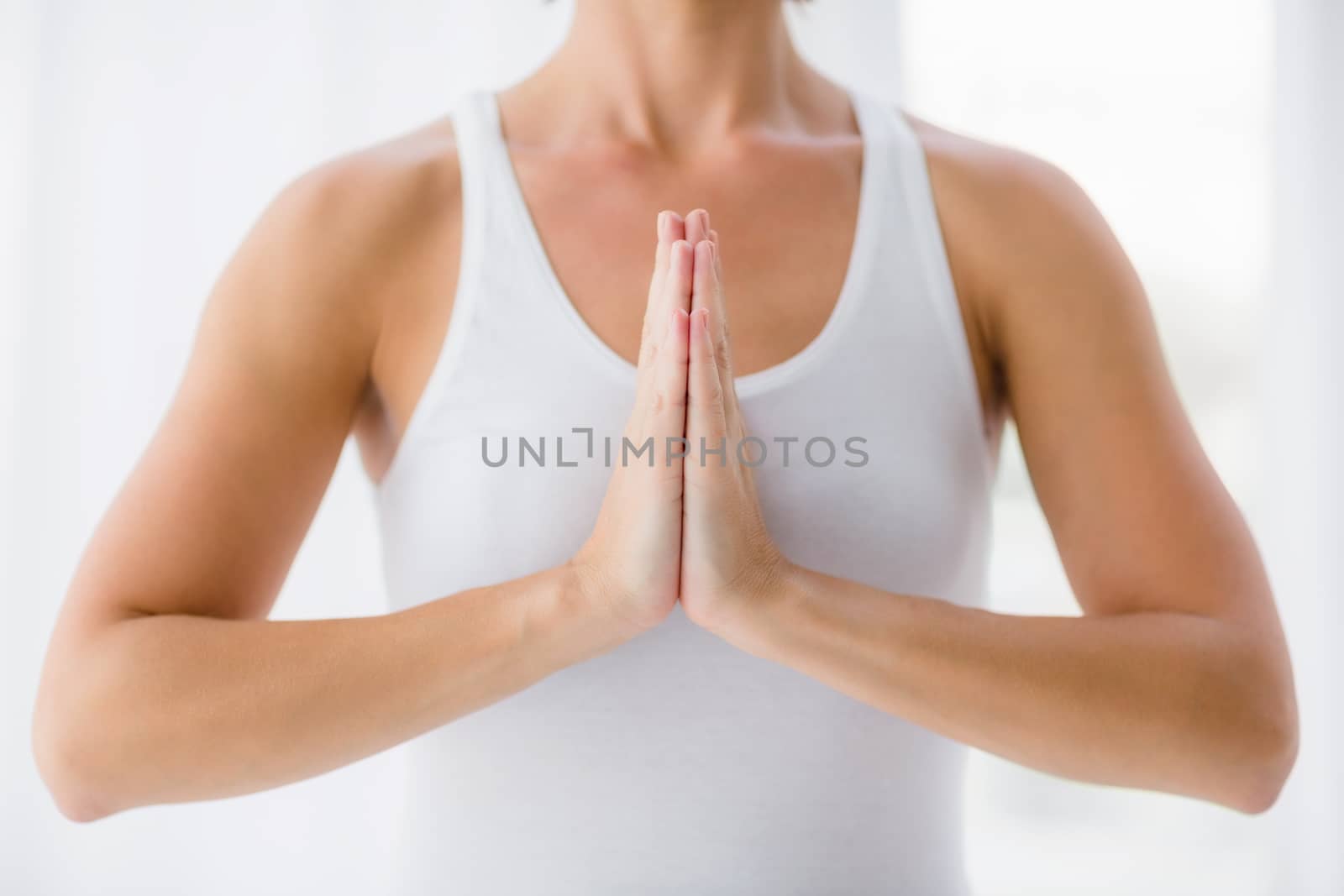Midsection of woman perfroming yoga by Wavebreakmedia